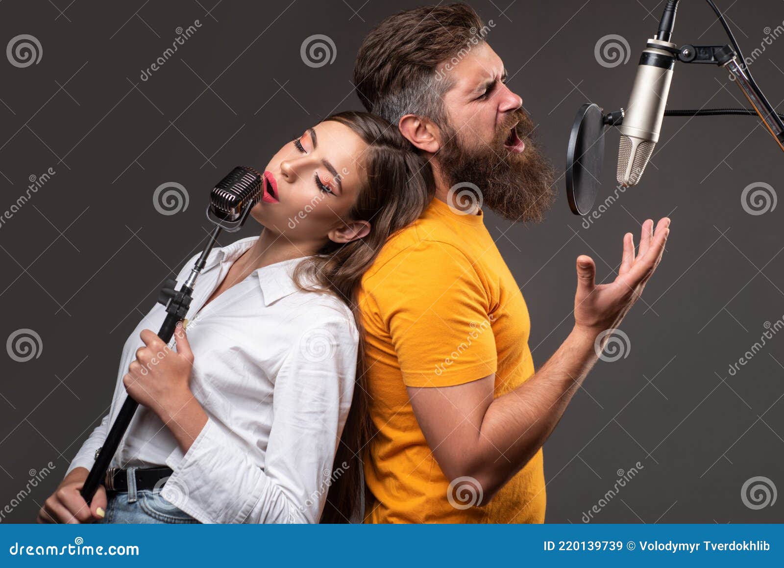 Couple Duet with Microphone Singing Song. Musician in Music Hall. Stock