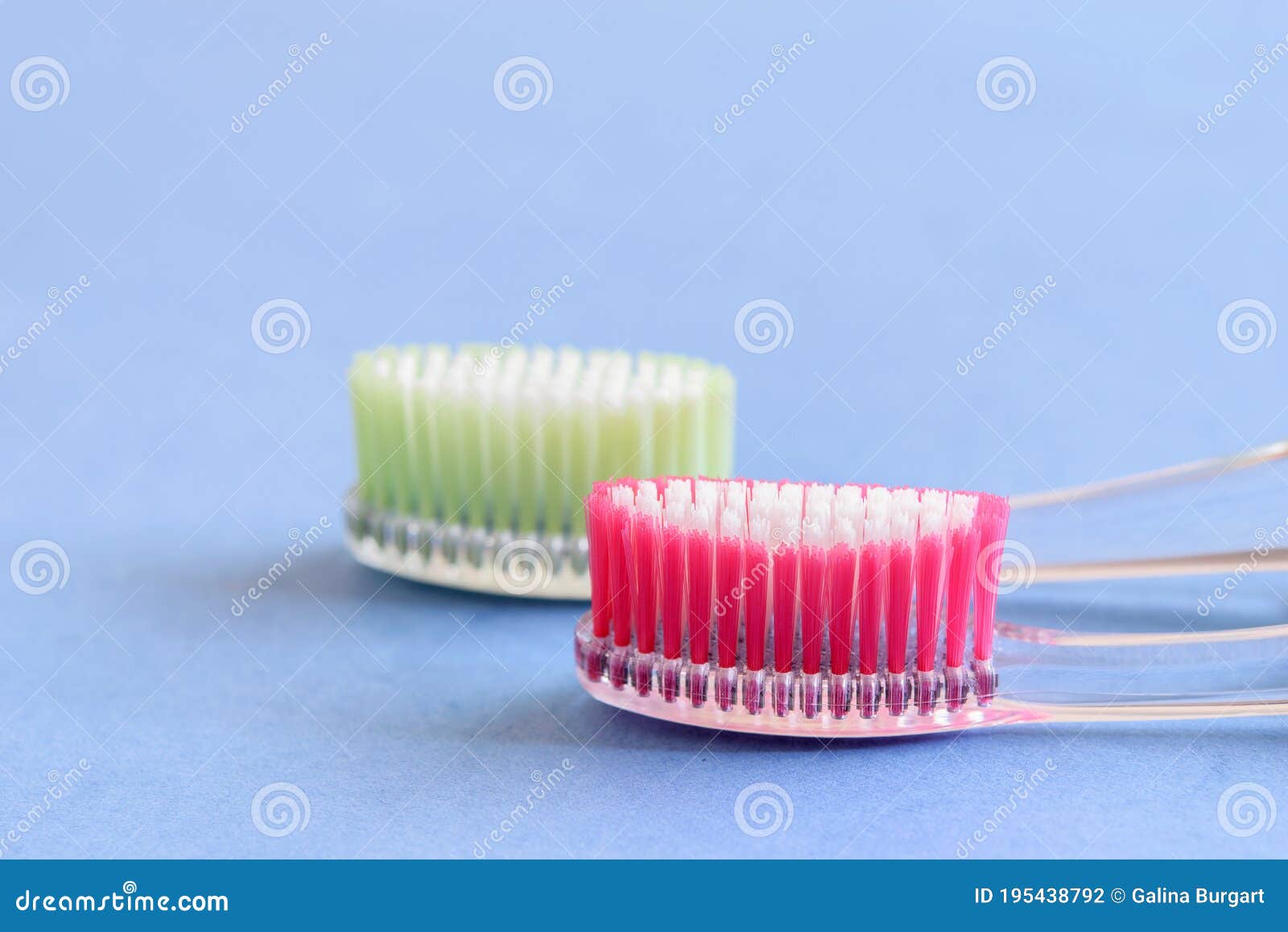 a couple of ecological plastic toothbrushes on the blue background close-up, 