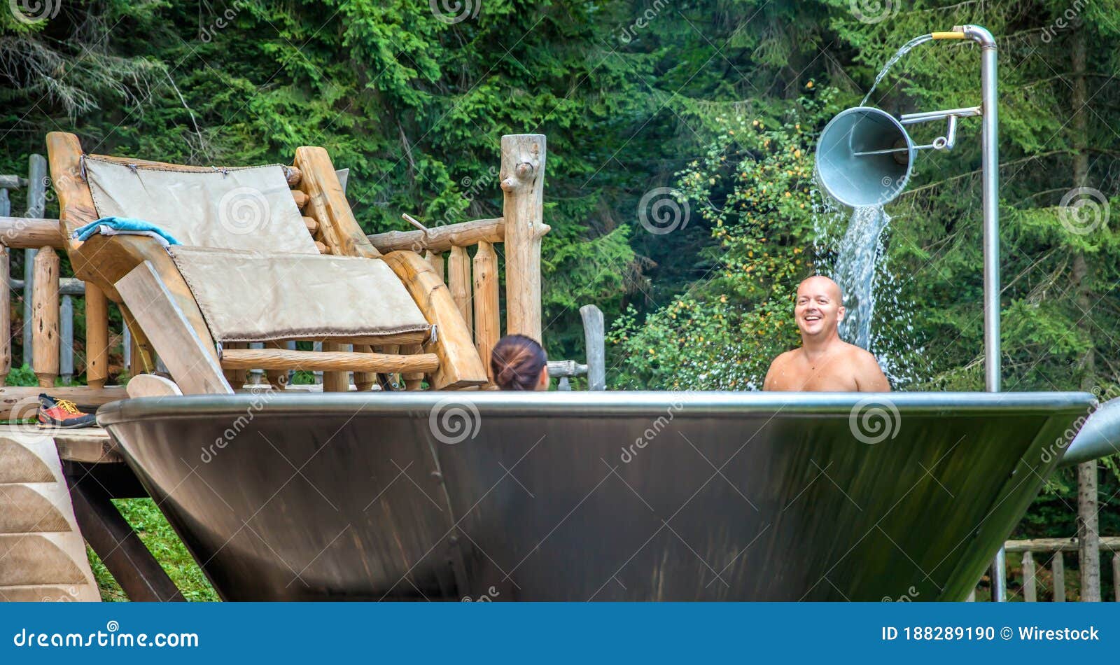 couple enjoying a good bath in a unique jakuzzi at hija glamping lake block in nova vos, slovenia