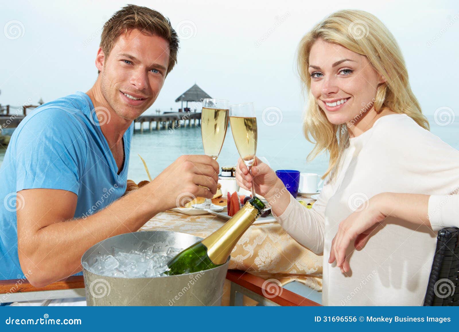 couple enjoying meal in seafront restaurant