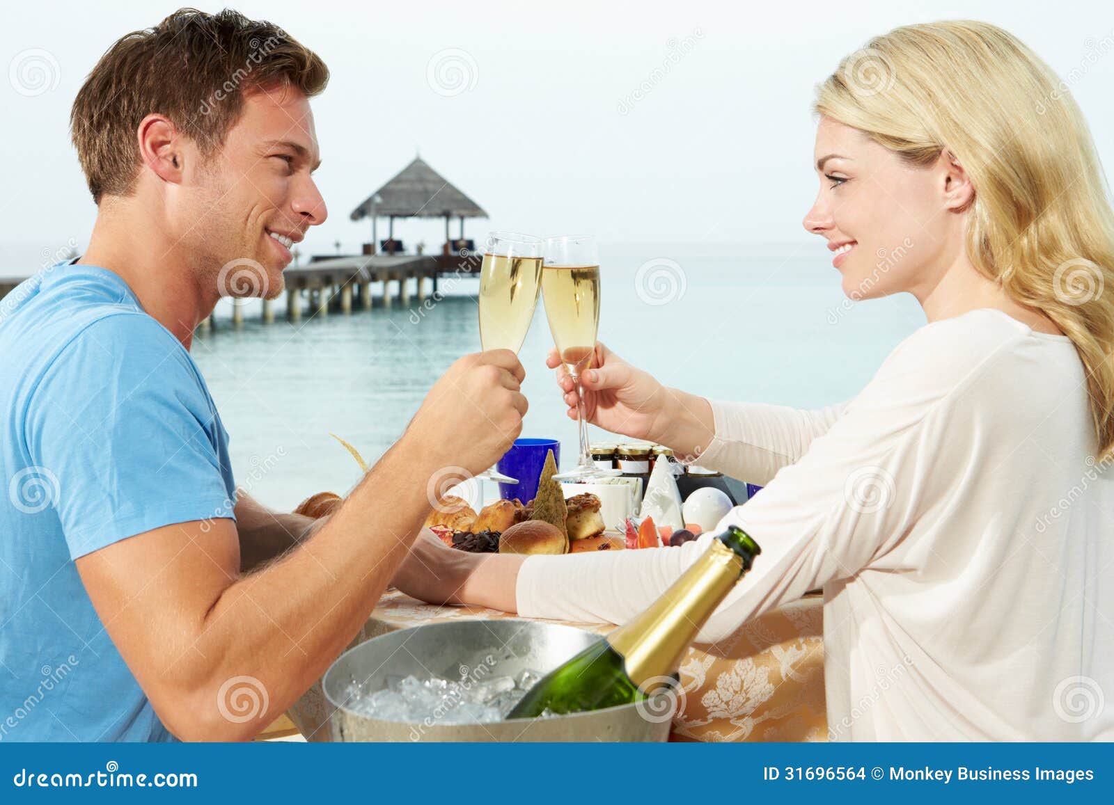 couple enjoying meal in seafront restaurant