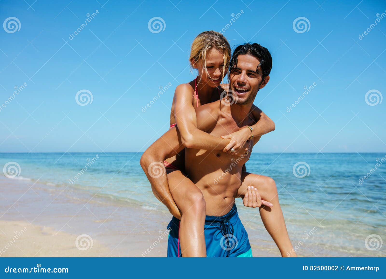 Young man giving his girlfriend a piggyback ride on the beach - a Royalty  Free Stock Photo from Photocase