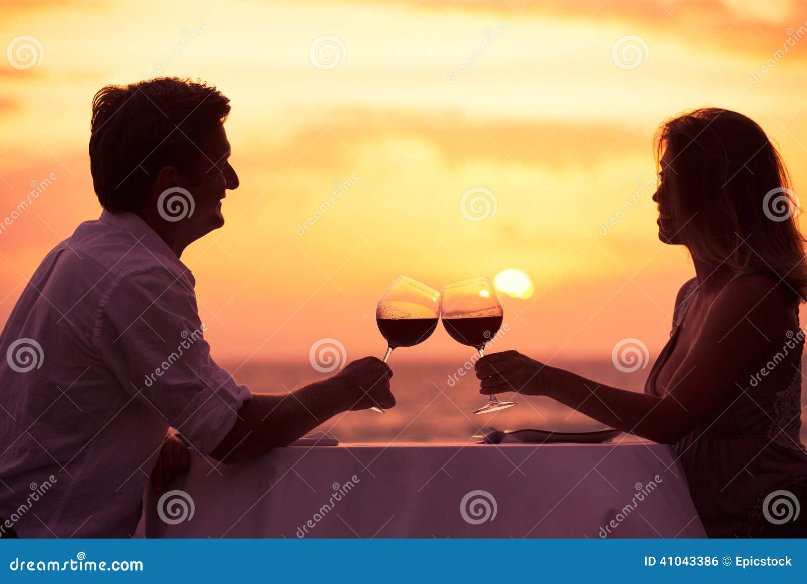 couple enjoying romantic sunnset dinner