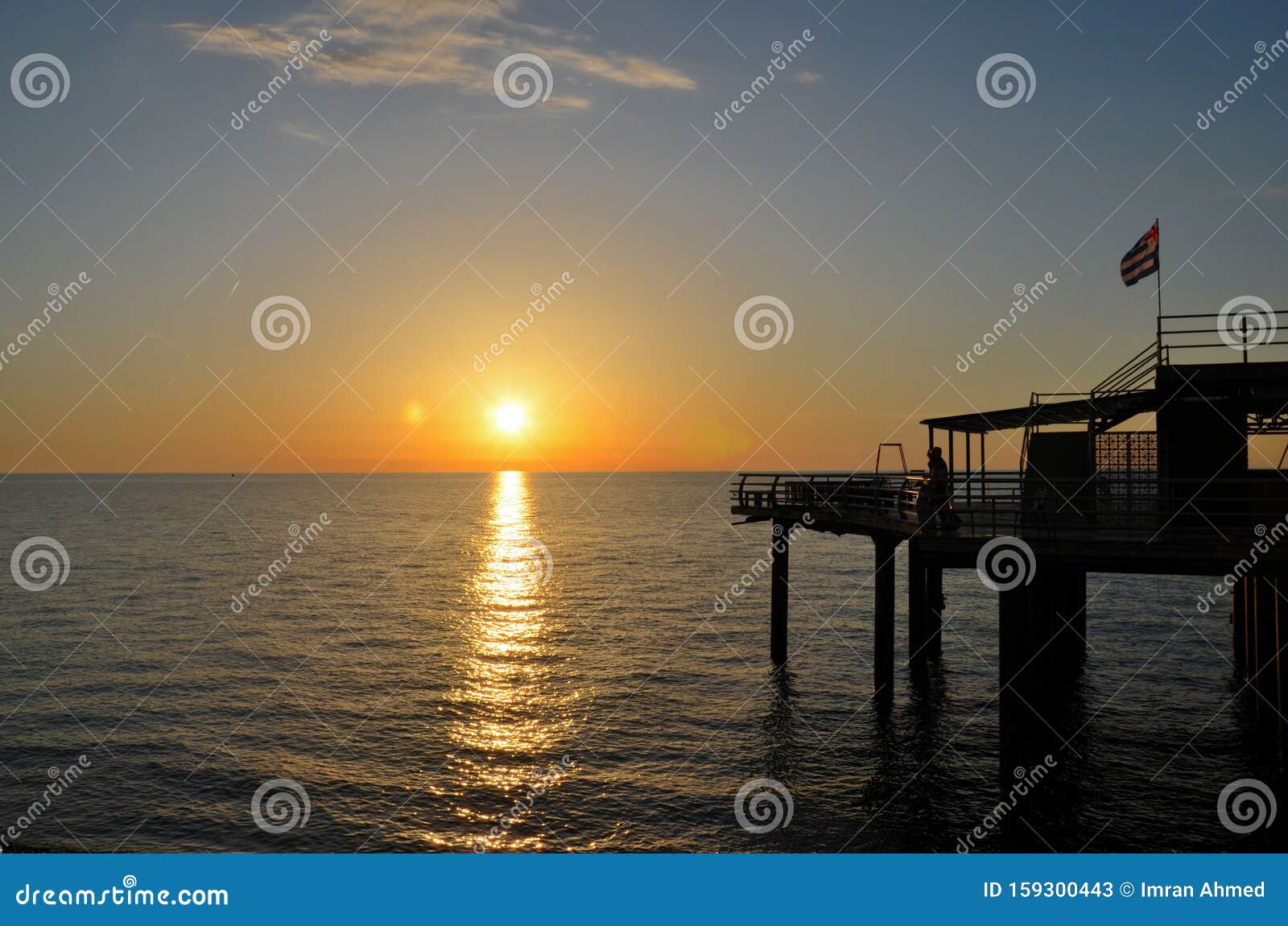 Couple Enjoys Sunset Over Black Sea Horizon at Pier with Flag Batumi ...