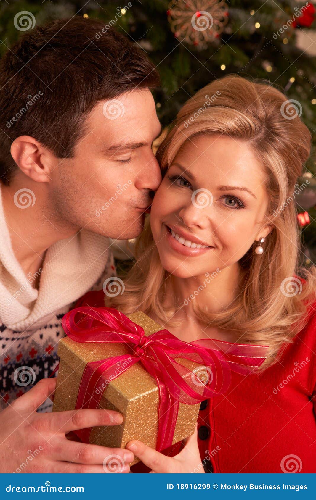 couple exchanging christmas gifts