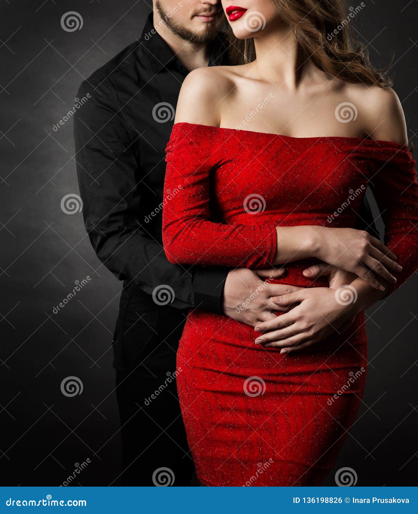 couple fashion beauty, woman in red dress and embracing man in love