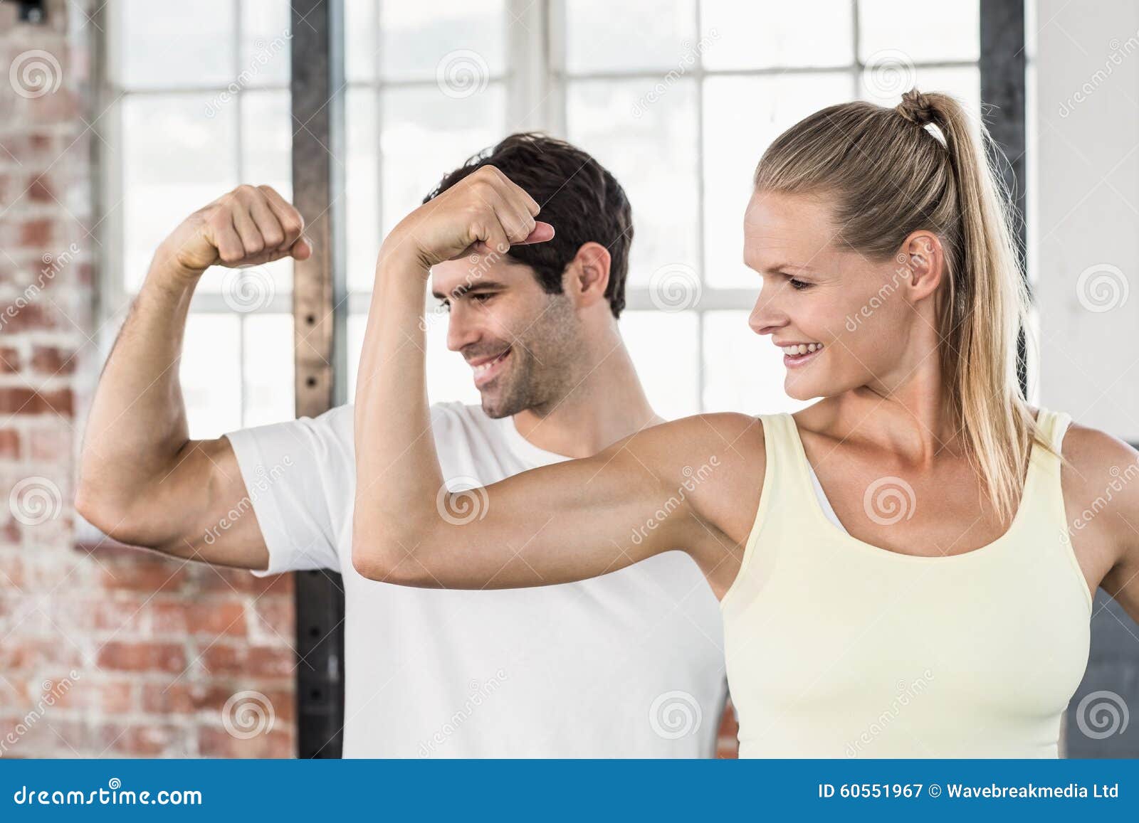 Couple Flexing Muscles at the Gym Stock Image Image of flexing