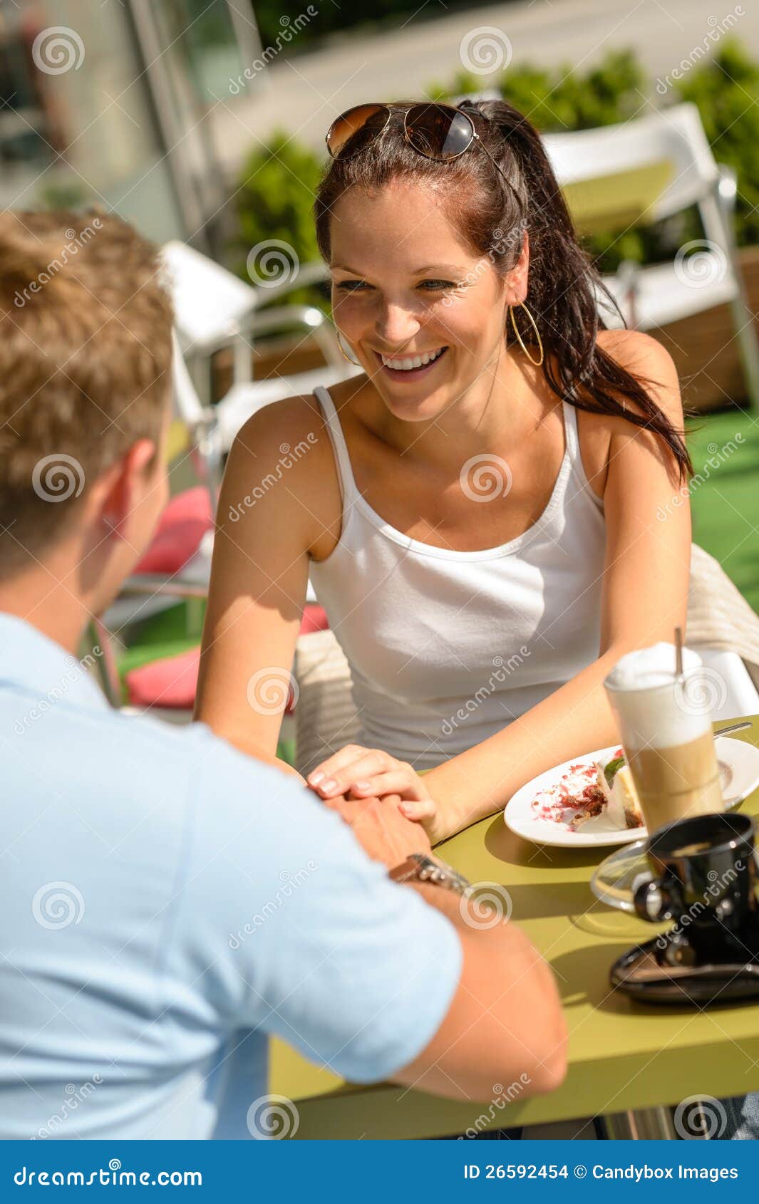 couple flirting holding hands at cafe bar