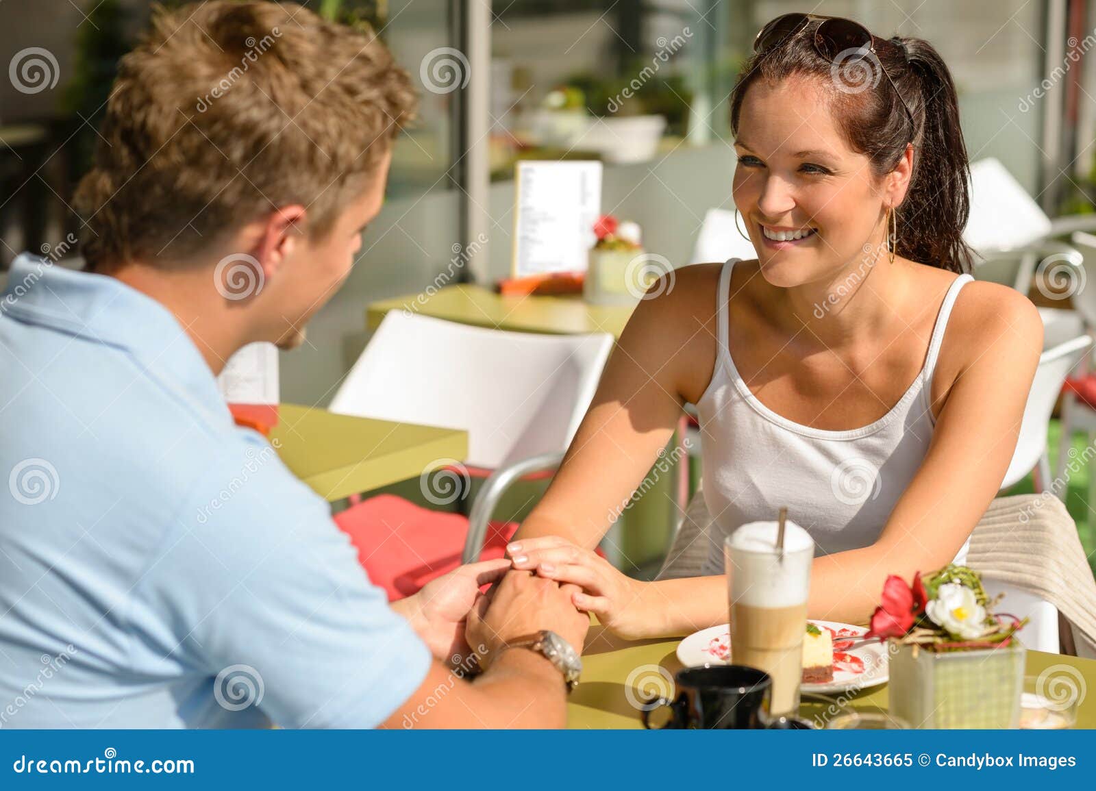 couple flirting holding hands at cafe bar