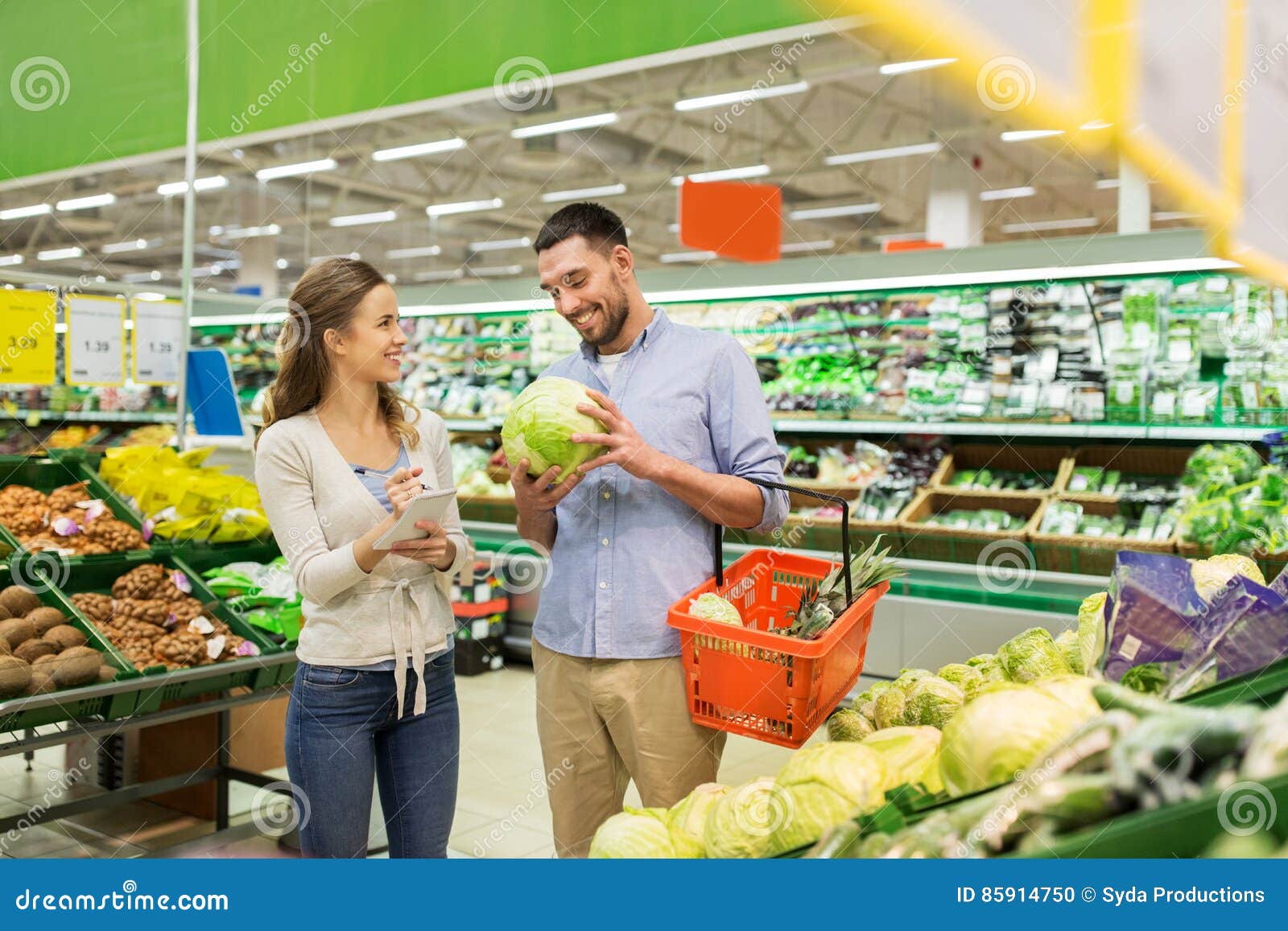 Couple With Food Basket Shopping At Grocery Store Stock