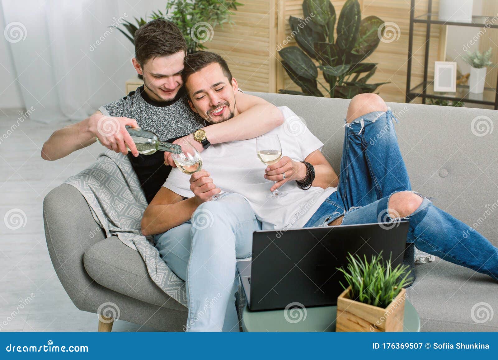 Couple Of Gay Having A Glass Of White Wine In Their Living Room Stock Image Image Of Cheerful