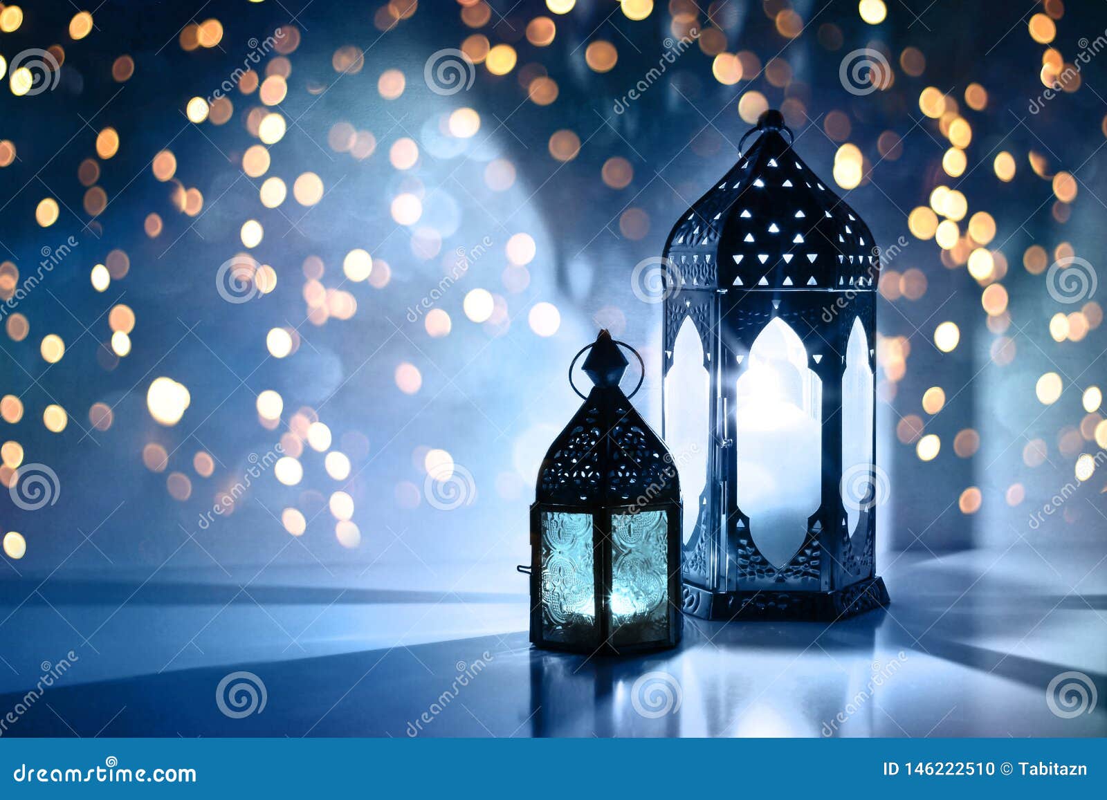 couple of glowing moroccan ornamental lanterns on the table. greeting card, invitation for muslim holy month ramadan