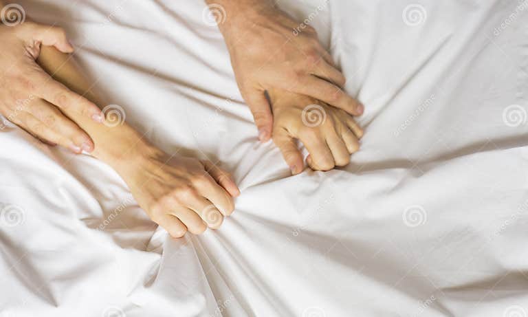 Couple Hands Pulling White Sheets In Ecstasy Orgasm Concept Of