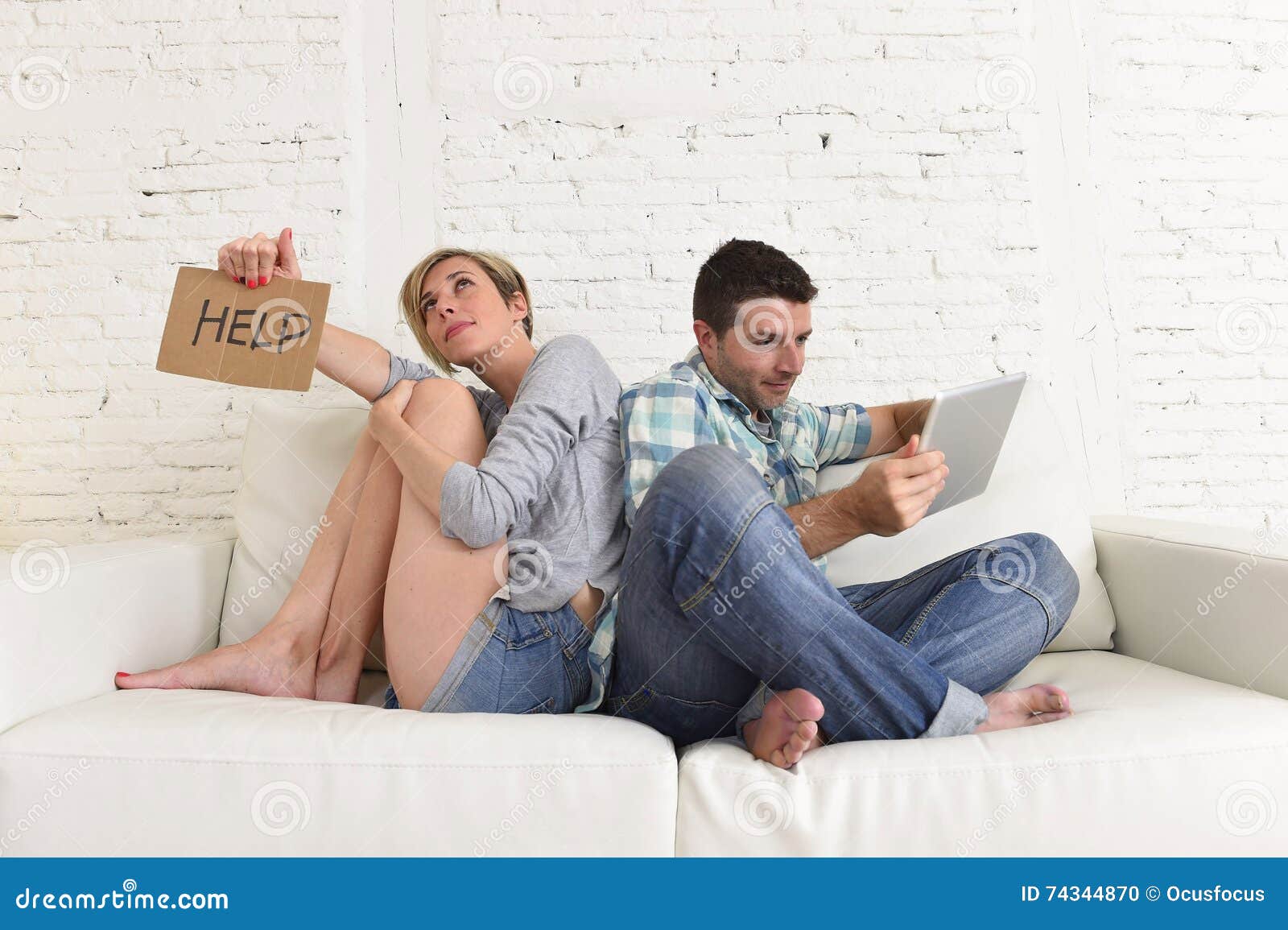 couple with happy husband using internet app on digital tablet pad ignoring bored and sad wife