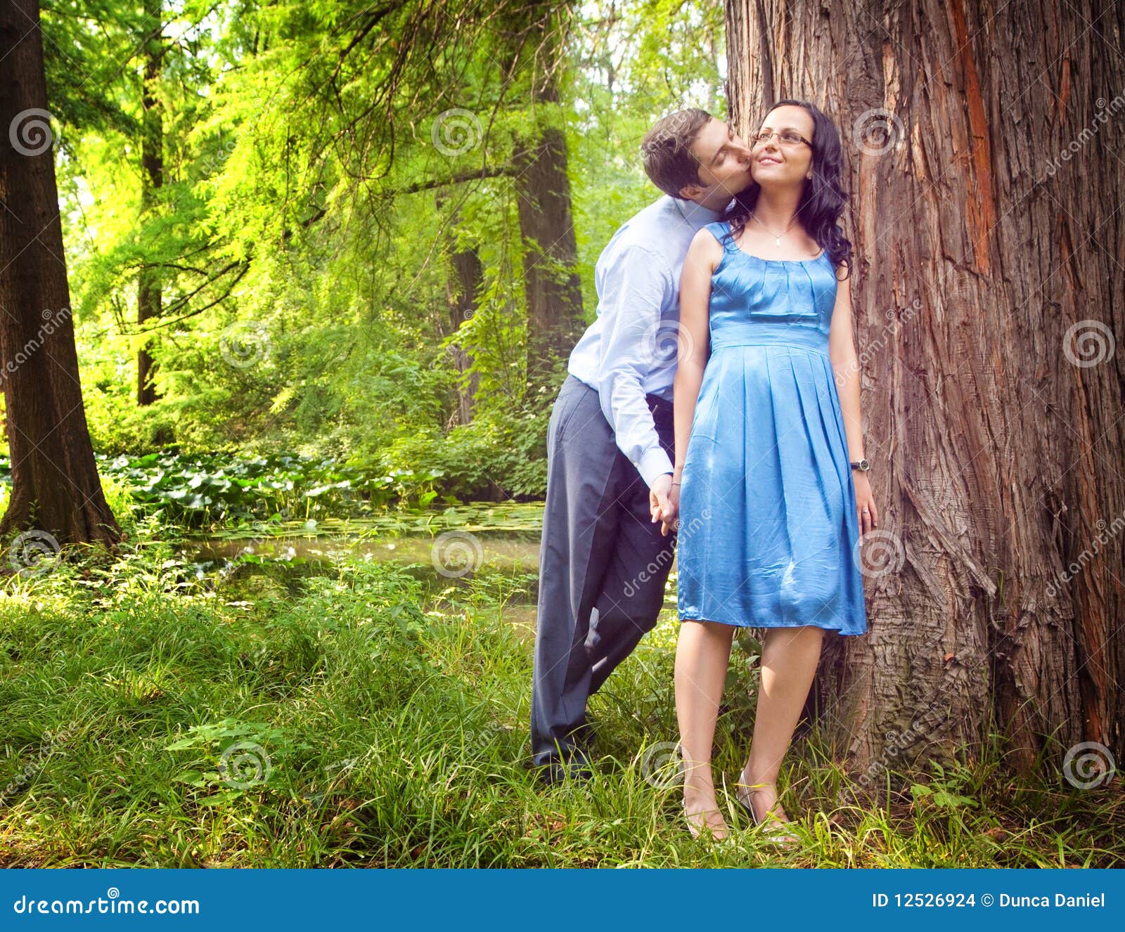 couple having a candid romantic kiss outdoor