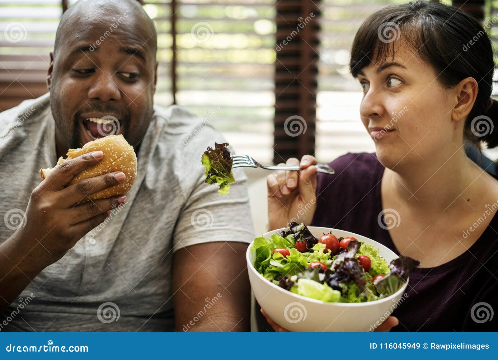 couple having fast food on the couch