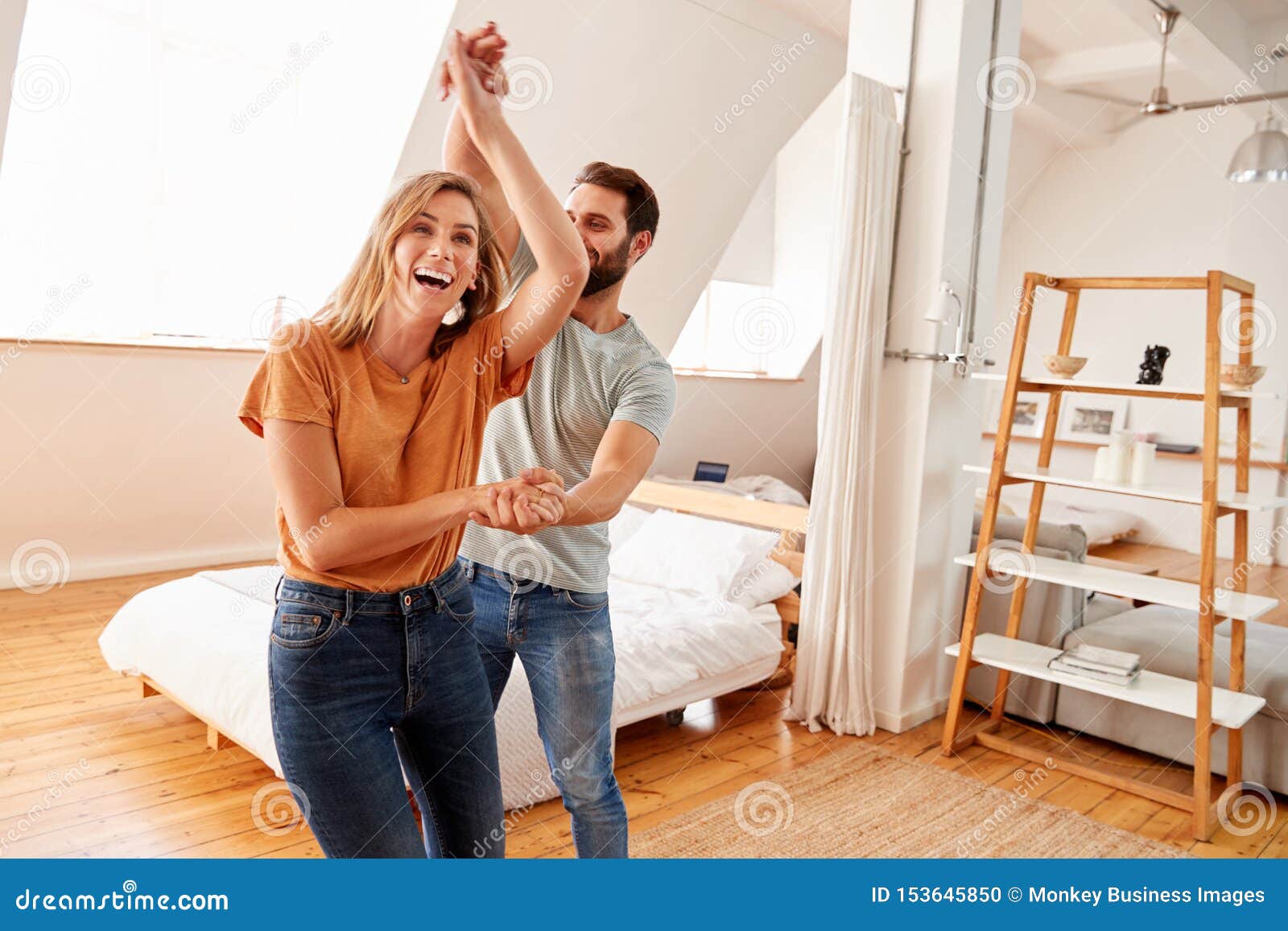 couple having fun in new home dancing together