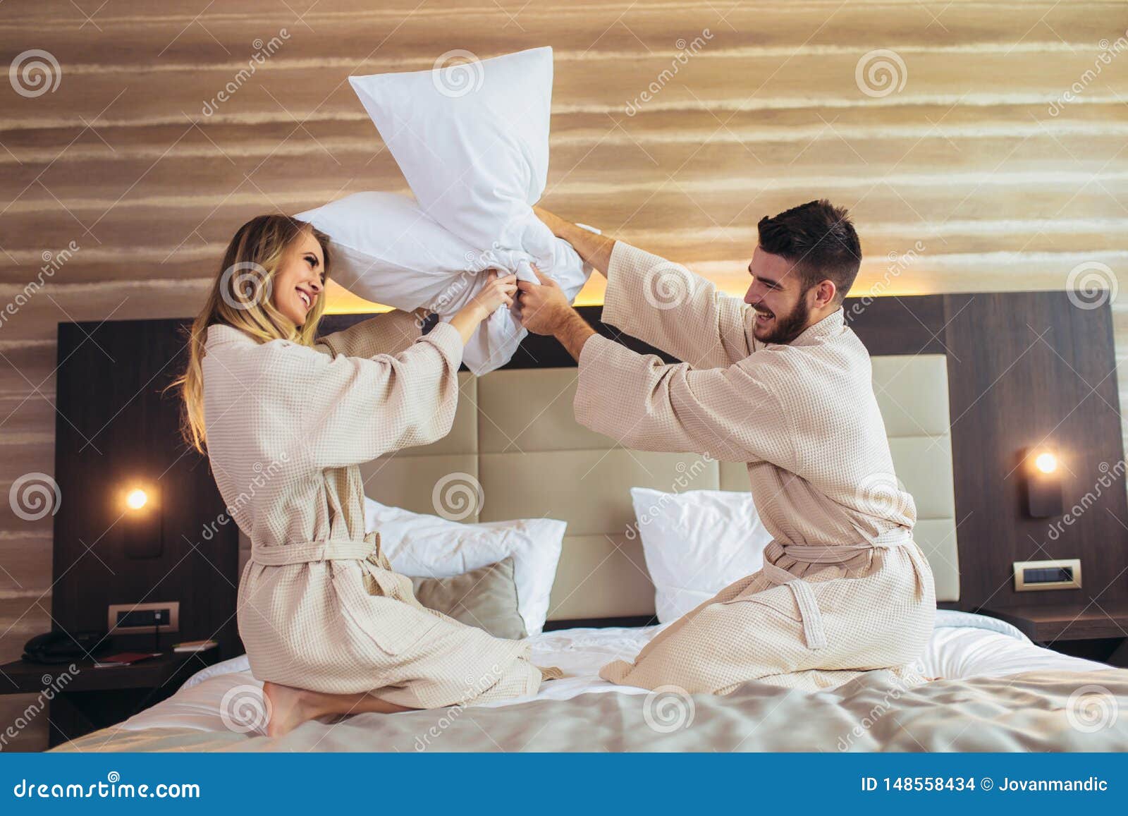 Couple Having Pillow Fight In Hotel Room Stock Photo Image Of Copy