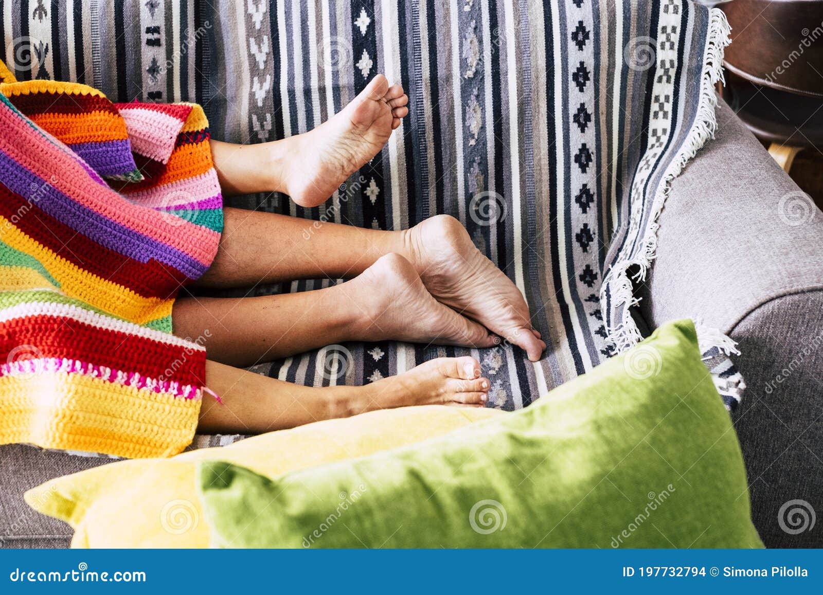 Couple Having Sex Activity Concept with Nude Feet and Coloured Cover on the Sofa at Home - People Lover and Sexual Active Stock Photo image