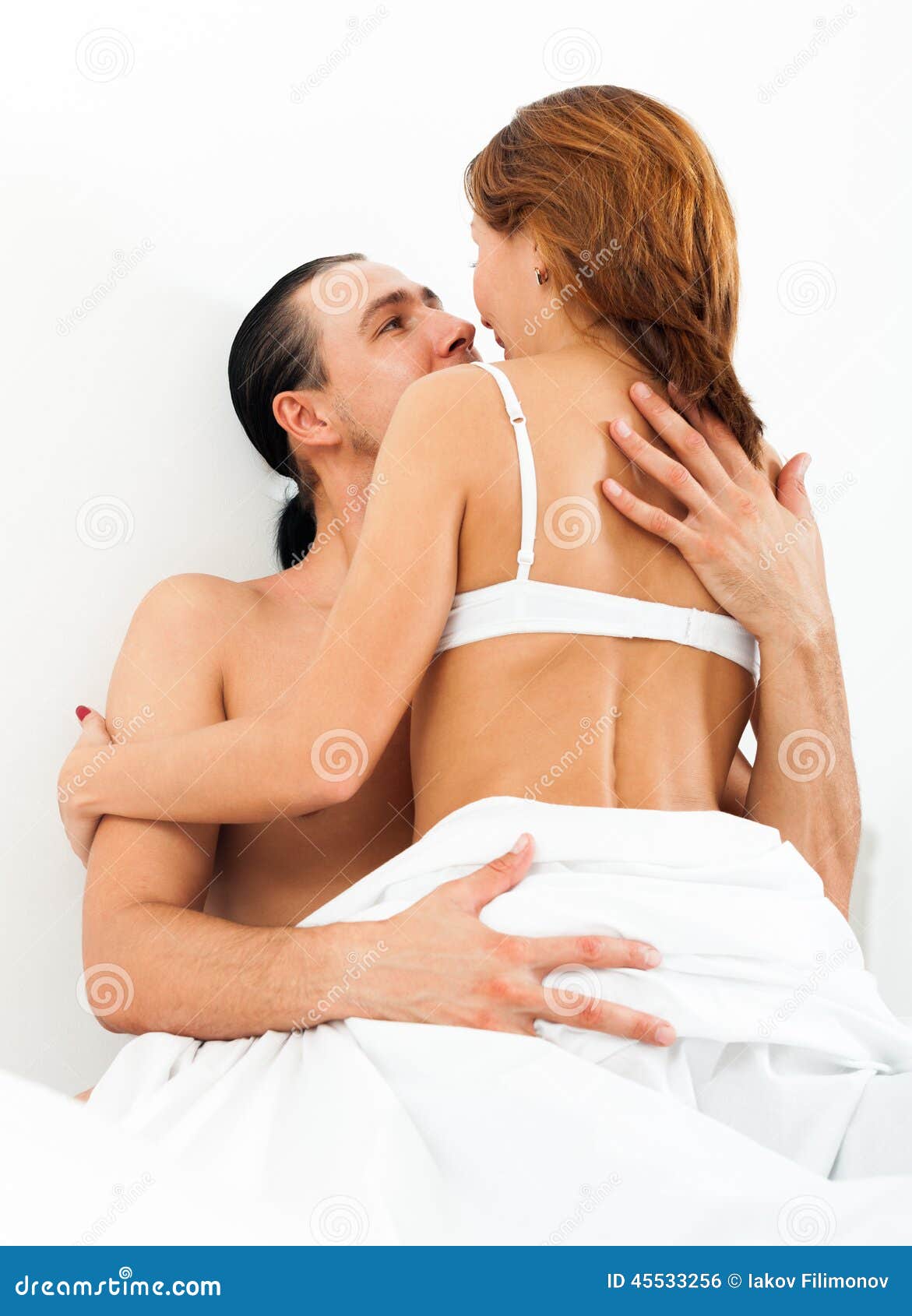 Couple having sex in bed stock photo