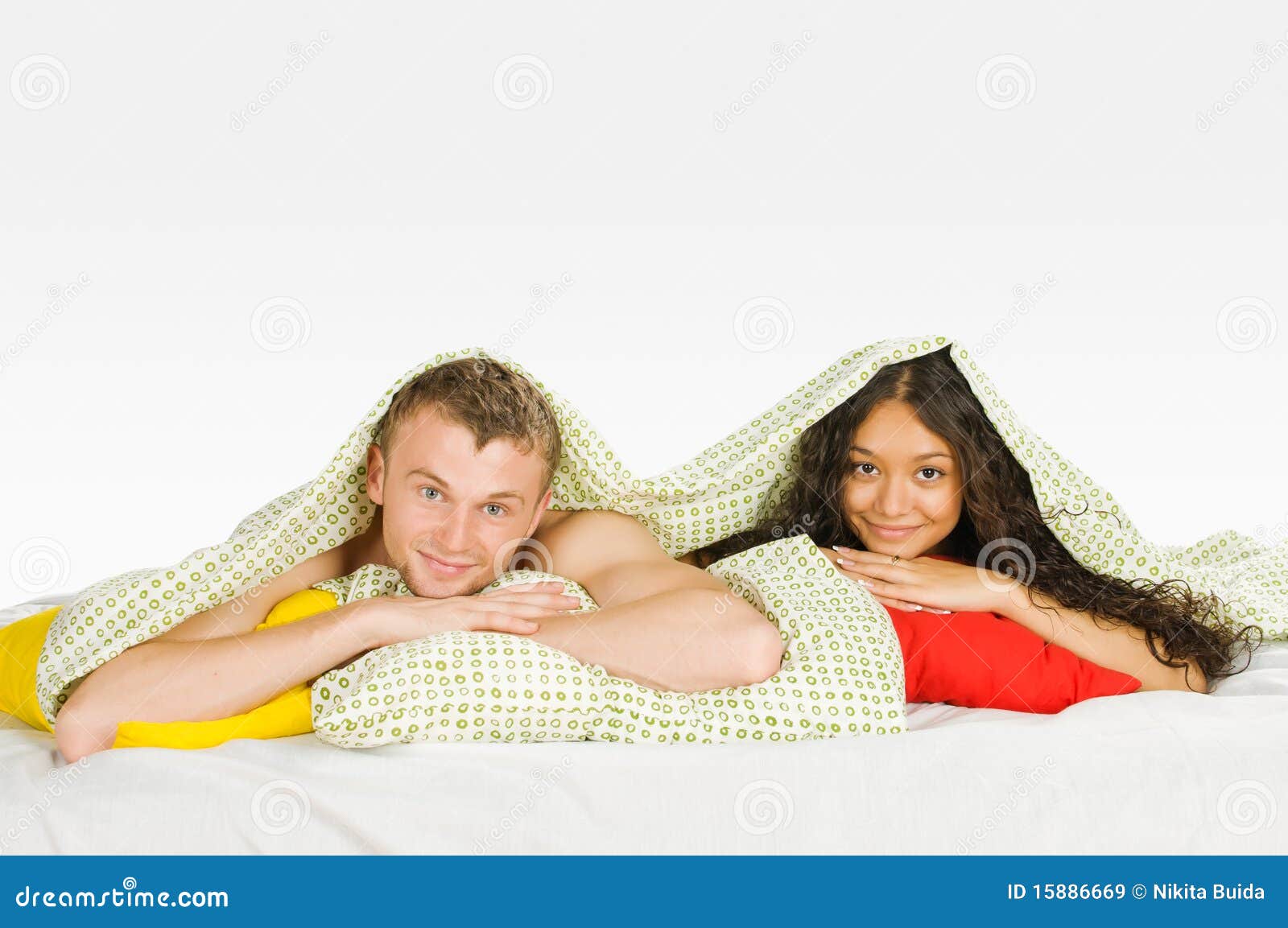 Couple Hiding Under Covers In Bed Royalty Free Stock Images - Image