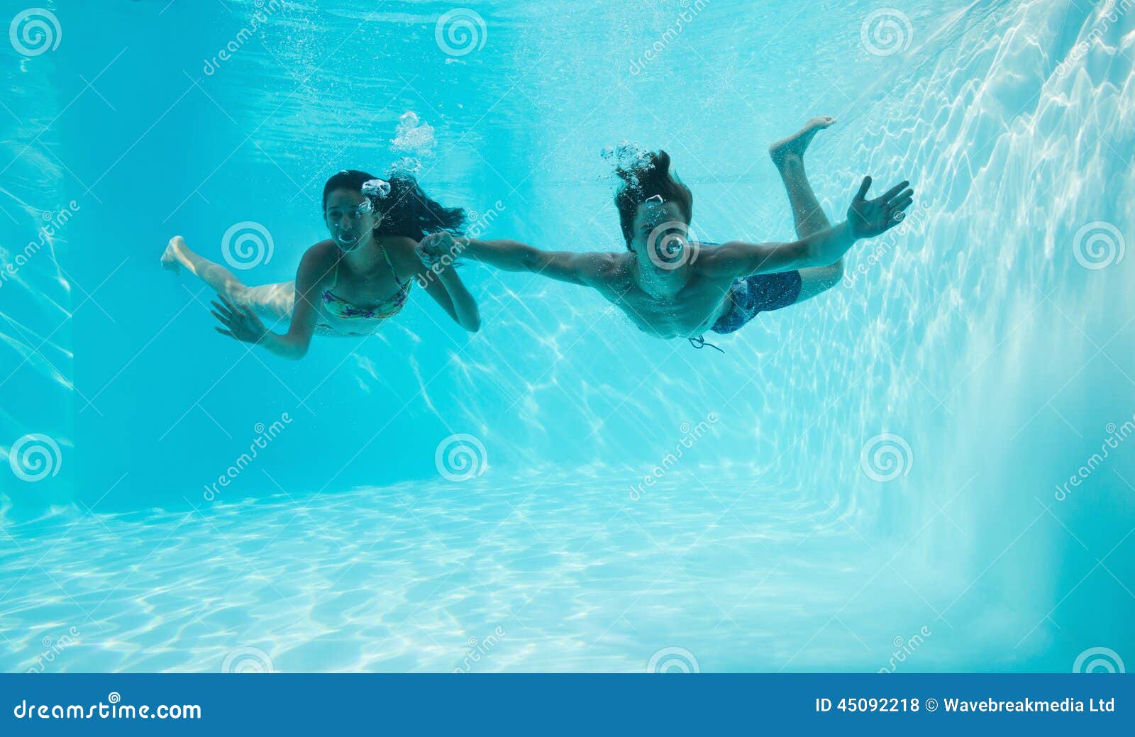Couple Holding Hands and Swimming Underwater Stock Photo Image of