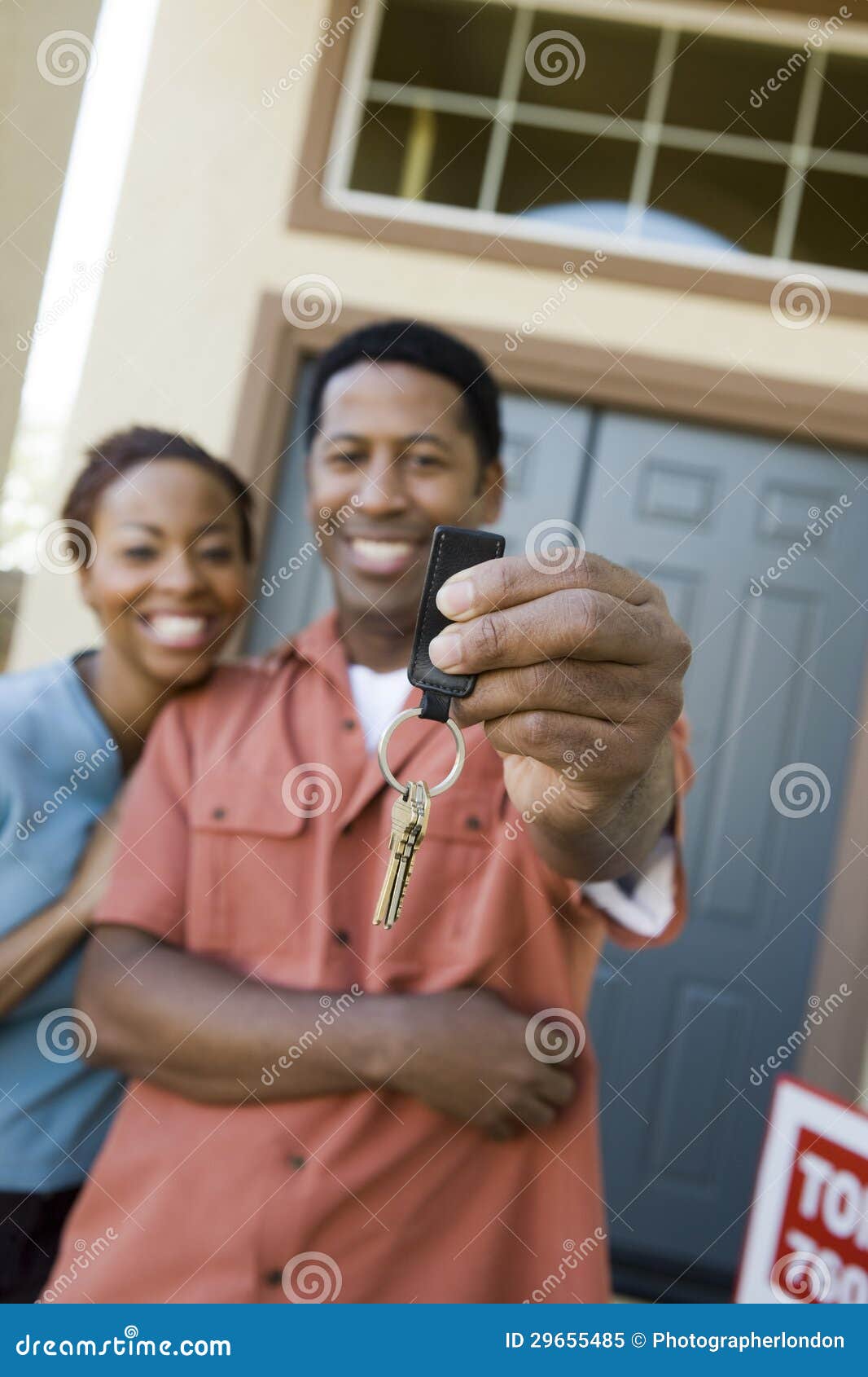 Couple Holding a Pair of House Keys Stock Image - Image of person