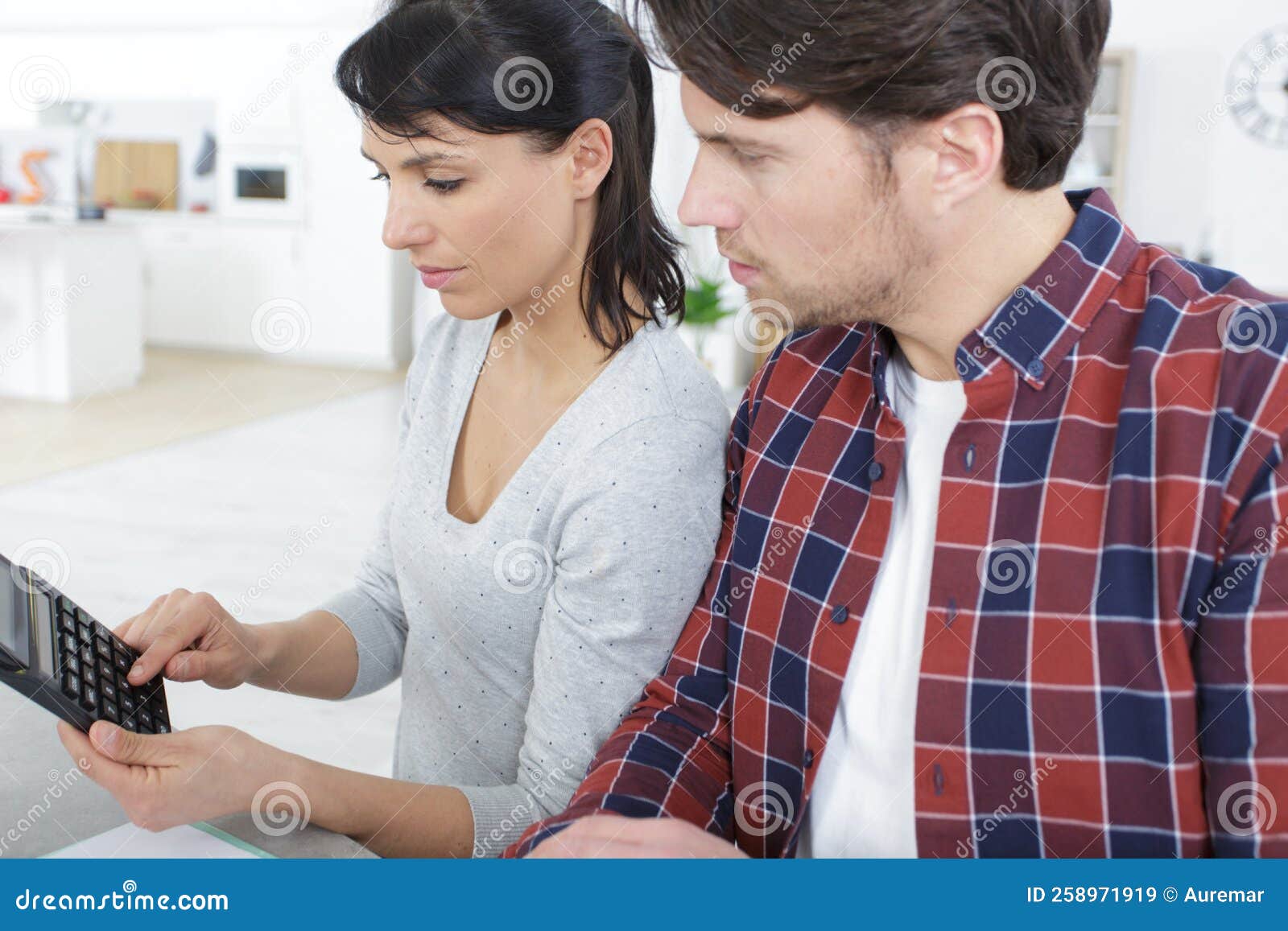 Couple at Home Using Calculator Stock Image Image of finances