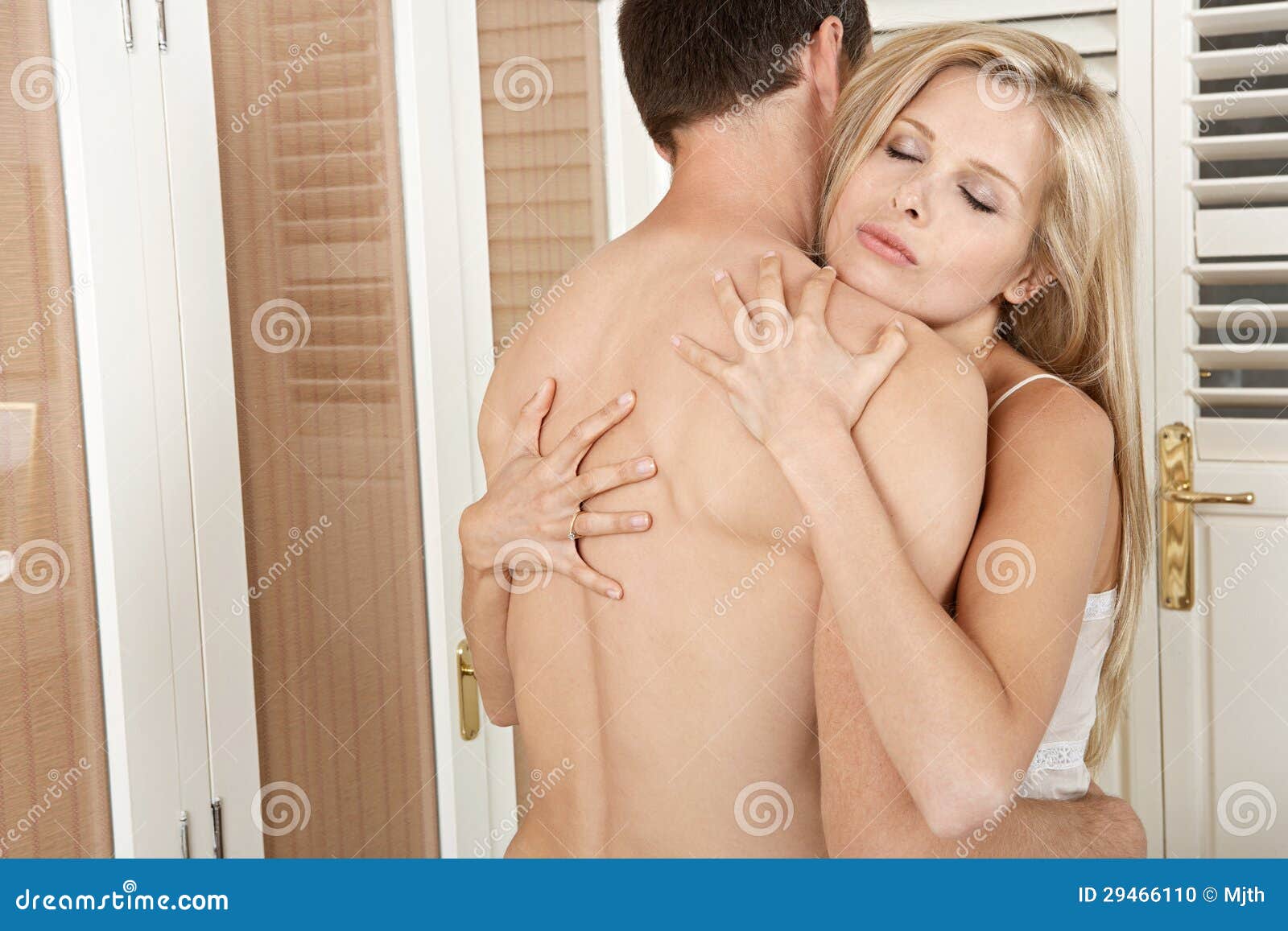 Couple Hugging And Kissing In Bedroom Stock Photo Image