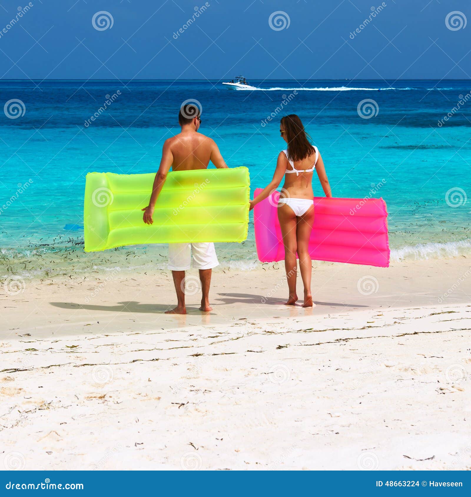 Couple with Inflatable Rafts on a Tropical Beach Stock Photo Image of
