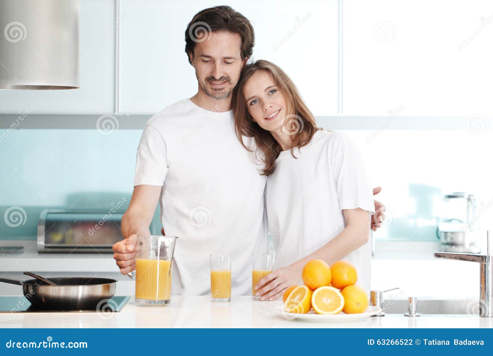 Couple with Juice in the Kitchen Stock Photo Image of woman
