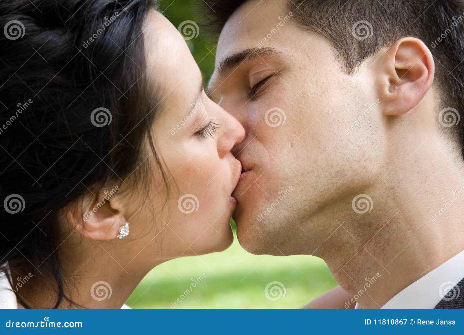 Passionate couple locked in intense kiss, bodies pressed close, evoking raw intimacy and desire