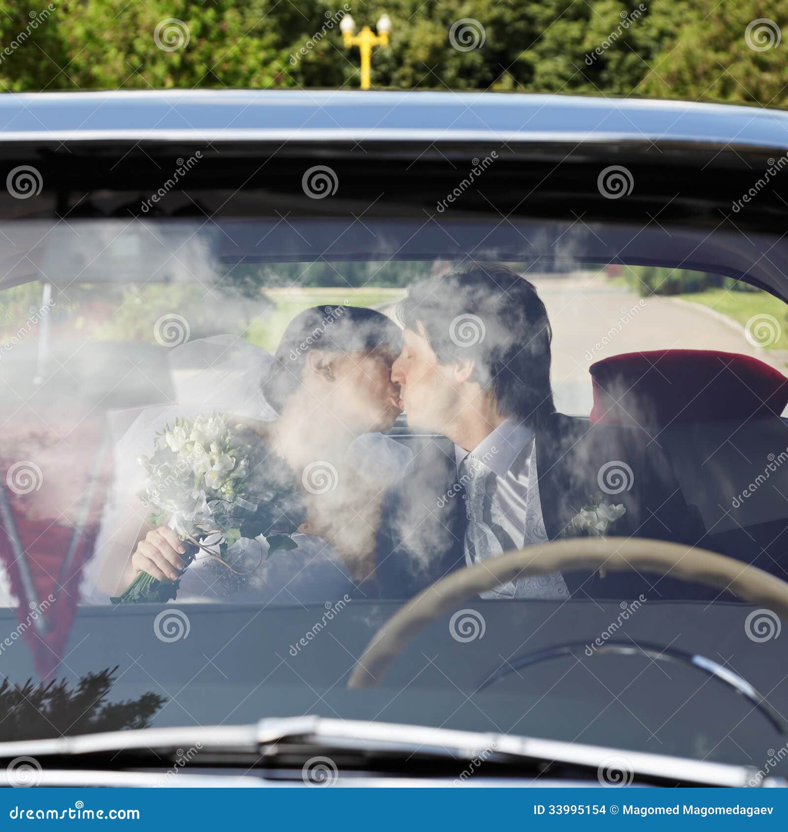 Couple kissing in car stock photo. Image of wedding, bride 33995154