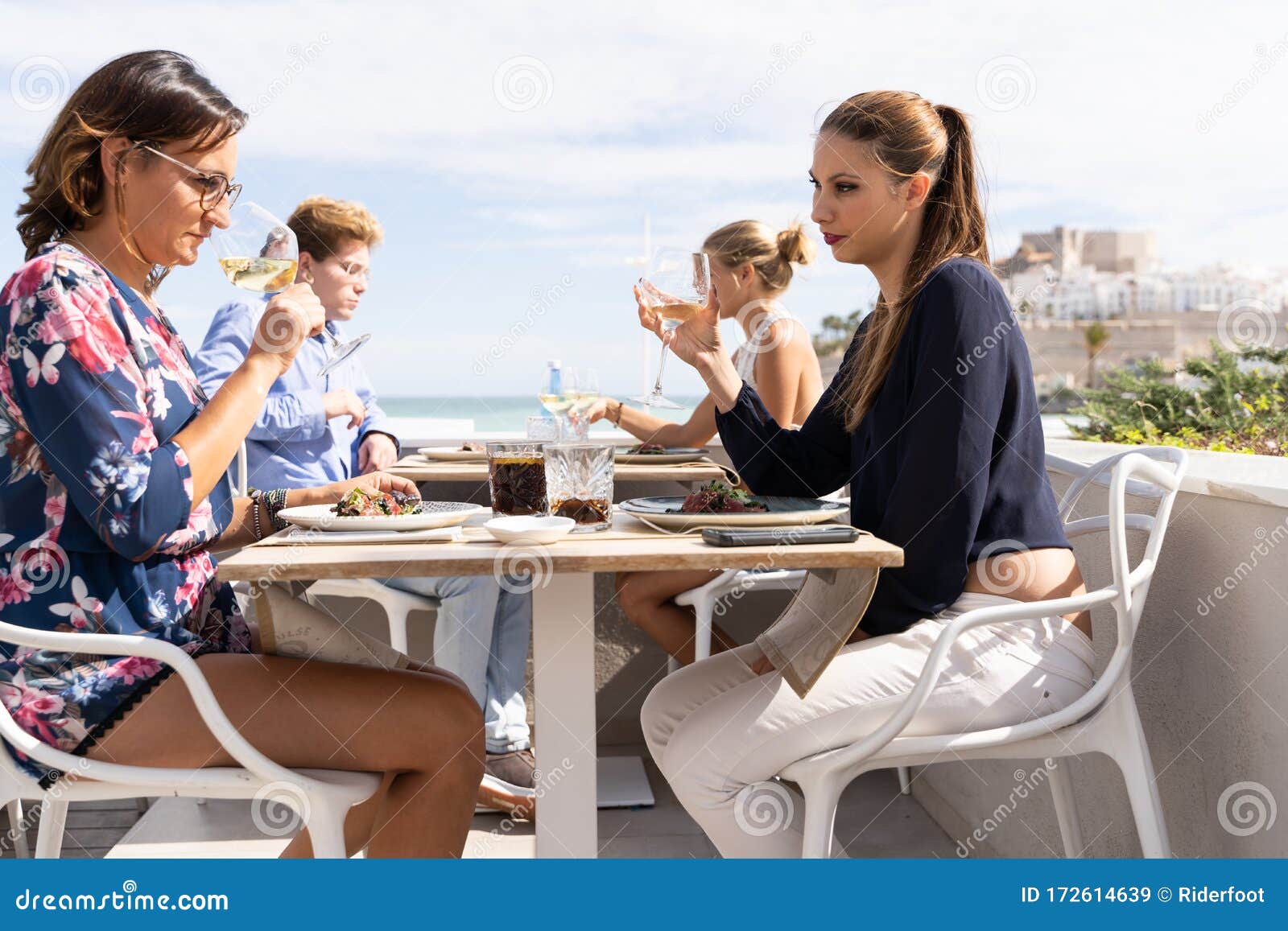 A Couple Of Lesbian Girls Drinking White Wine On A Terrace Of A 