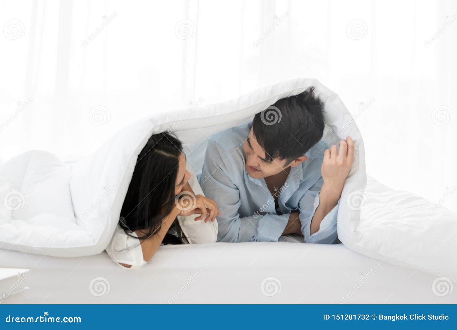 Couple Lie Prone And Put Blanket Cover Their Head Stock Photo