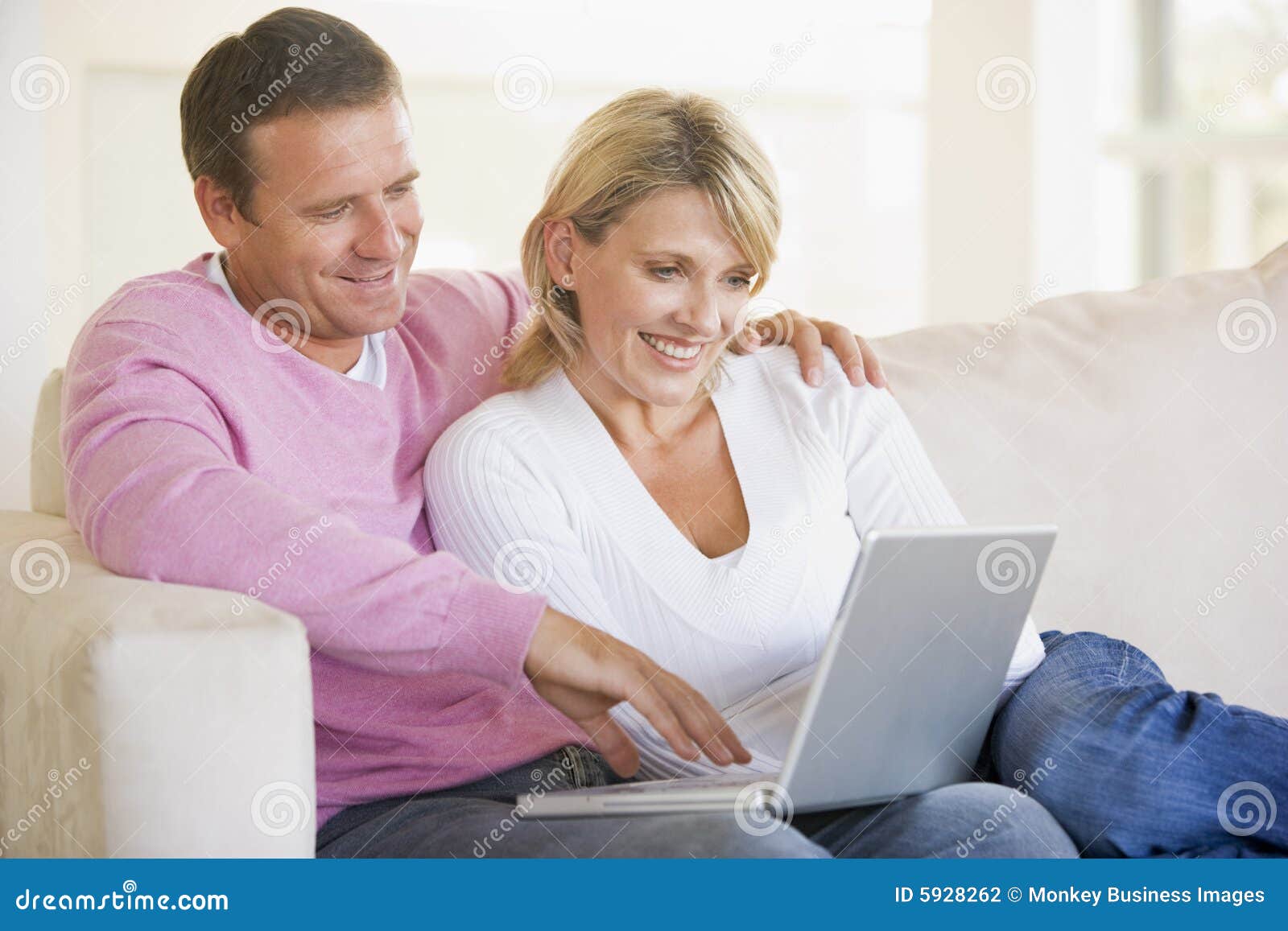 Couple in Living Room Using Laptop and Stock Photo - Image of internet ...