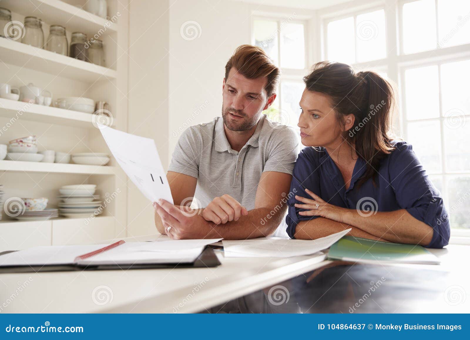 couple looking at domestic finances at home together