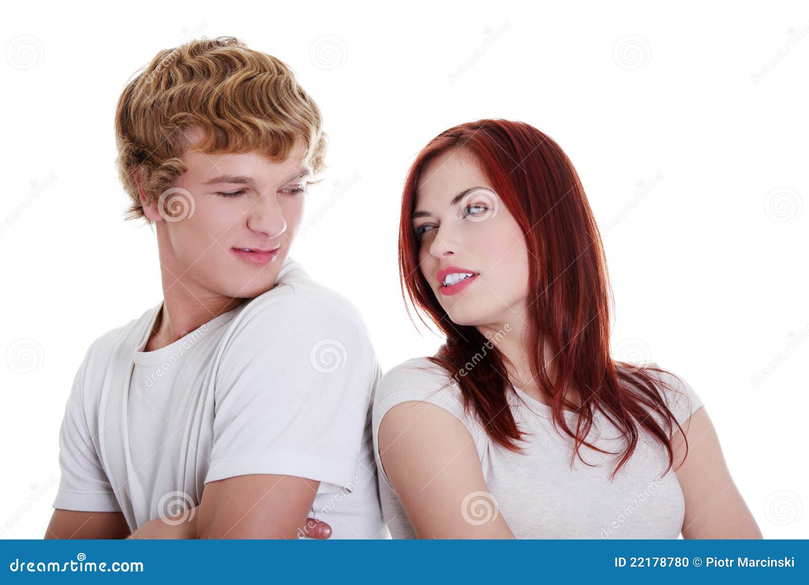 Young caucasian couple looking at each other. Isolated on white background.