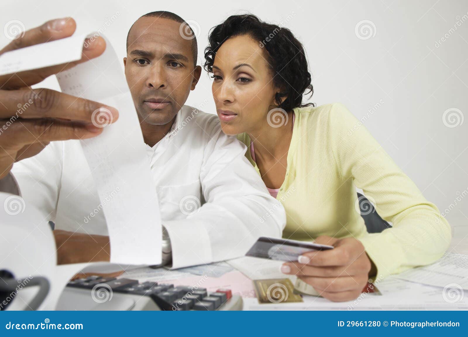 couple looking at expense receipt at home