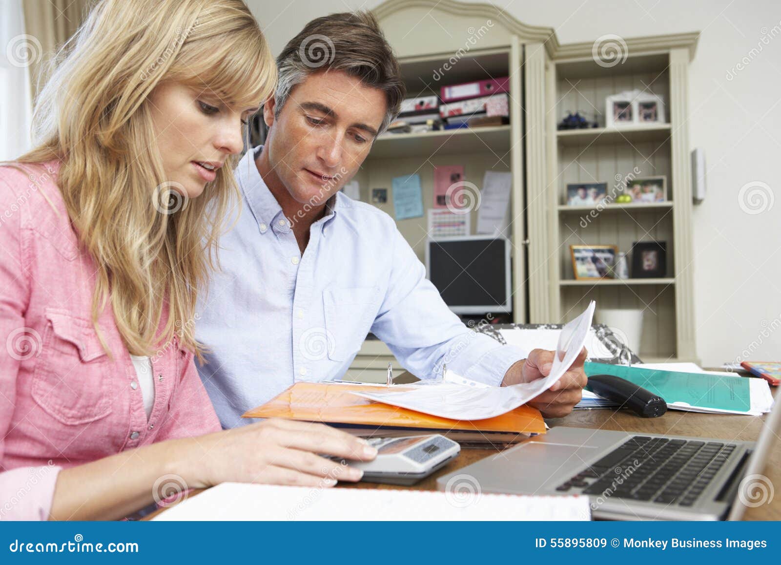 Couple Looking at Finances in Home Office Together Stock Image Image