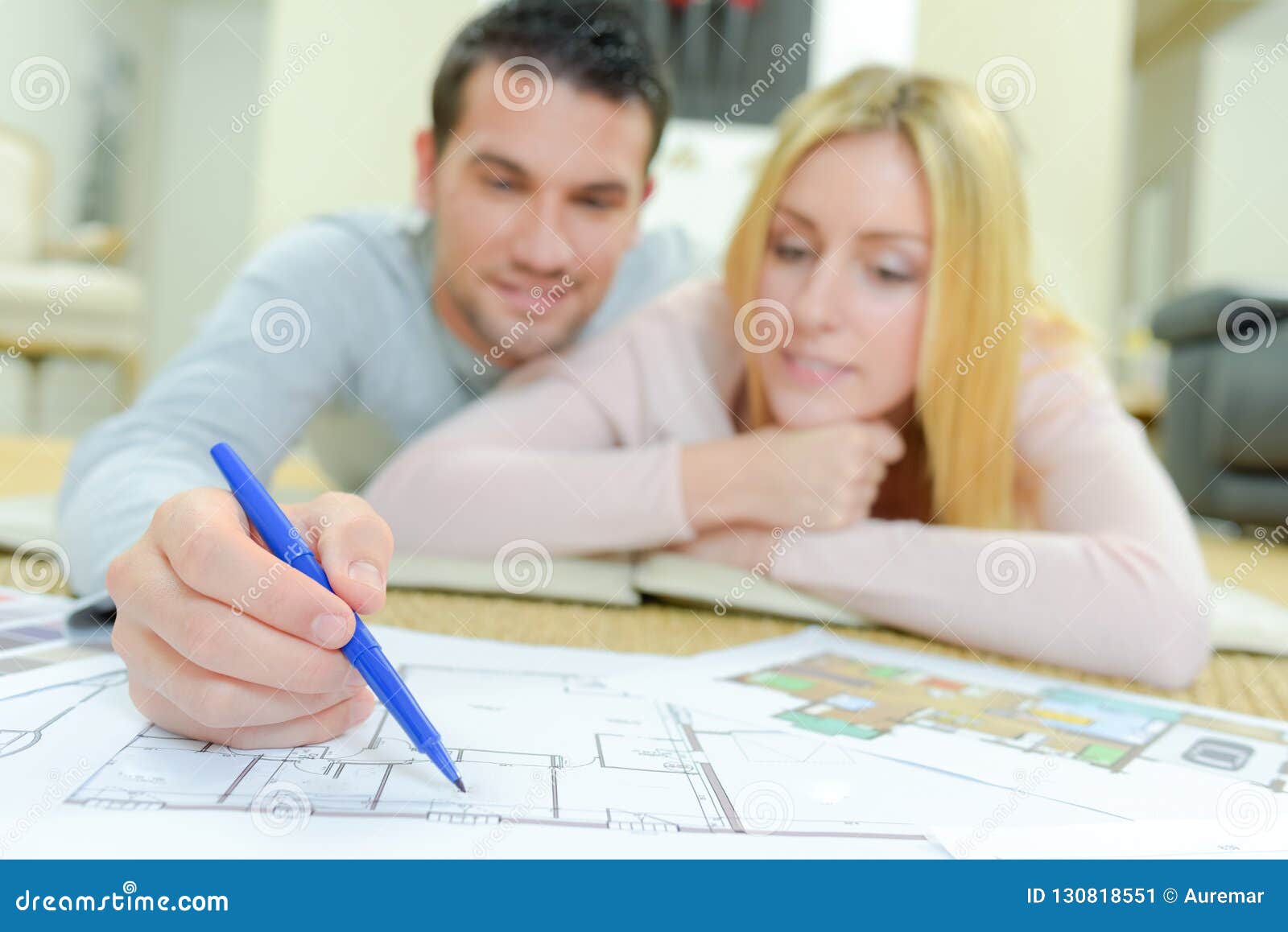 Couple Looking at House Plans Stock Image - Image of blueprints, front