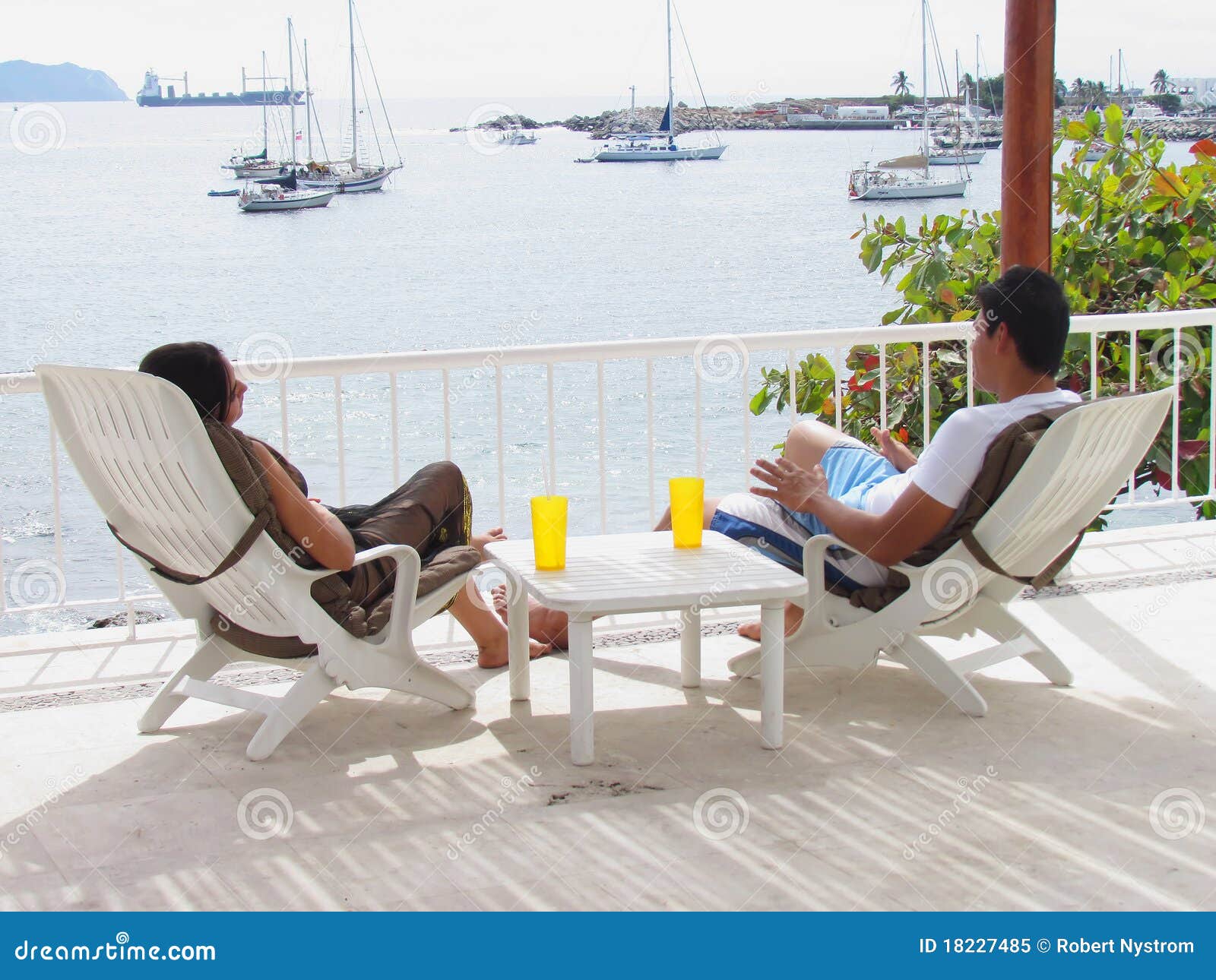 Couple in lounge chairs stock image. Image of chairs 18227485