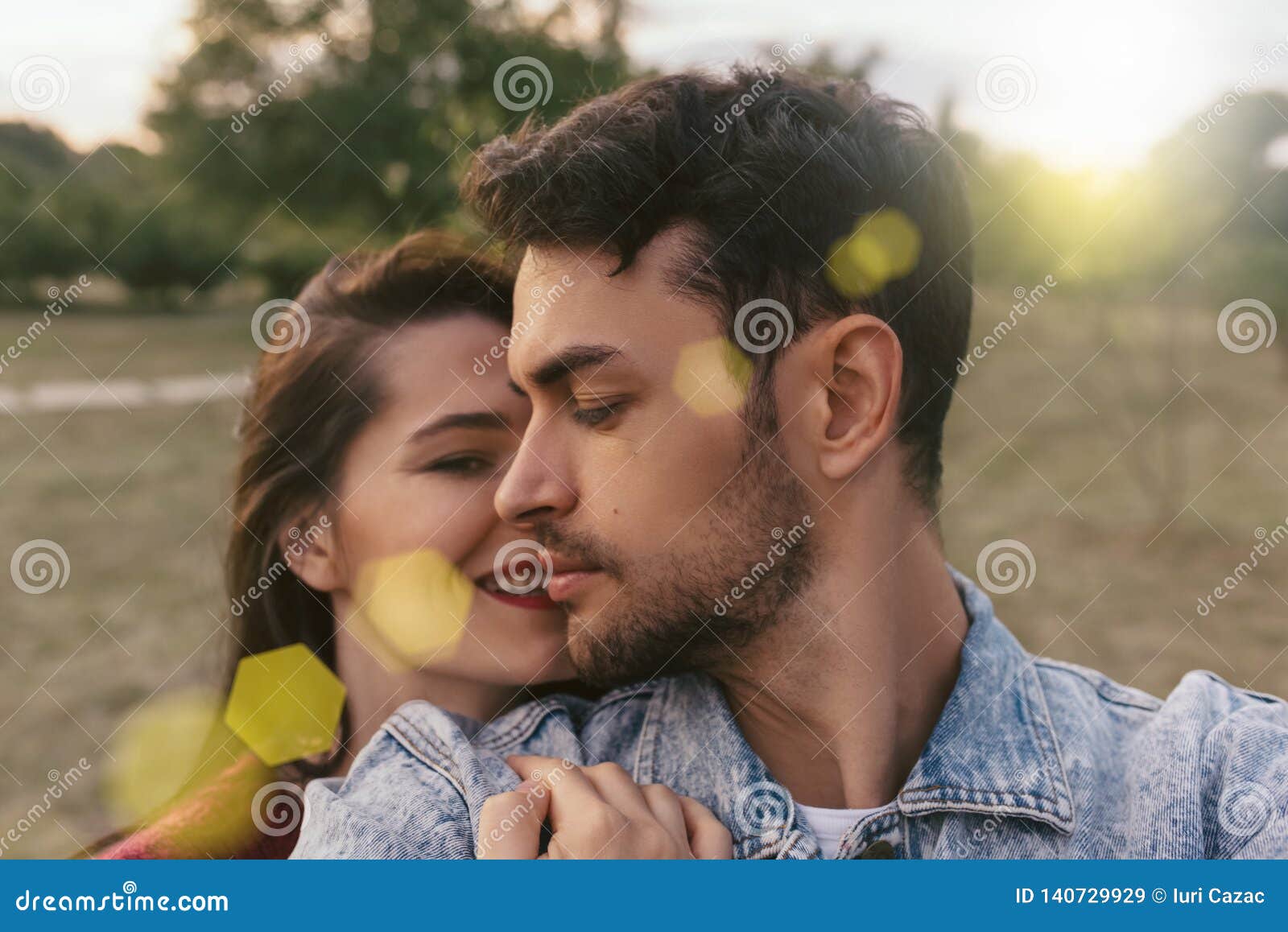 Couple in Love Enjoying Sunshine Embracing Each Other Looking with Love