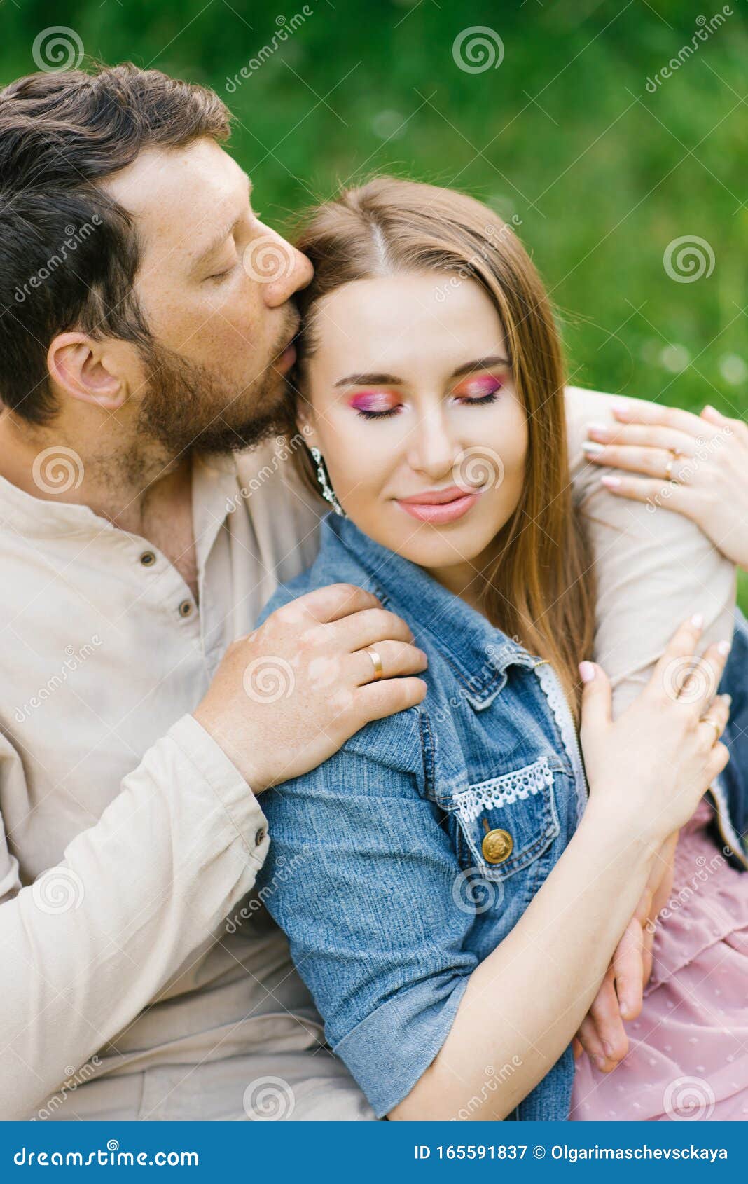 Couple In Love The Guy Kisses The Girl On The Temple And Hugs Her Valentine`s Day Stock Image