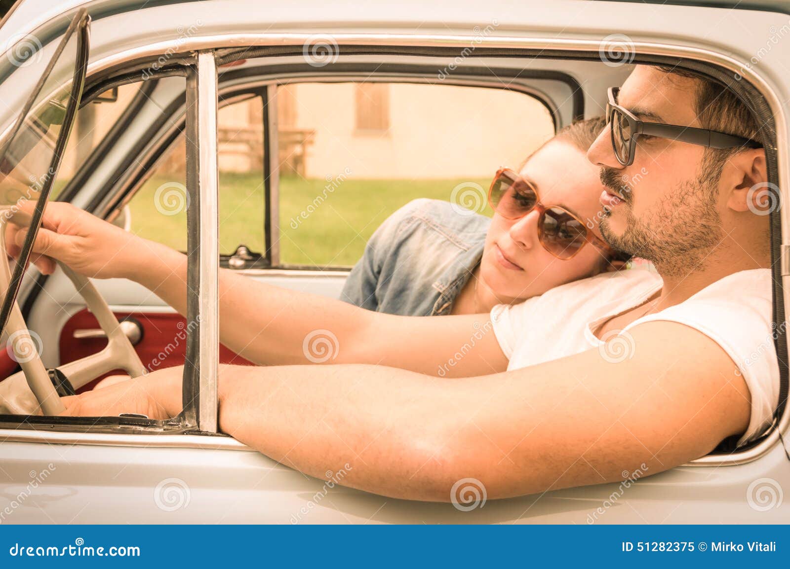 couple in love having a rest during honeymoon vintage car trip