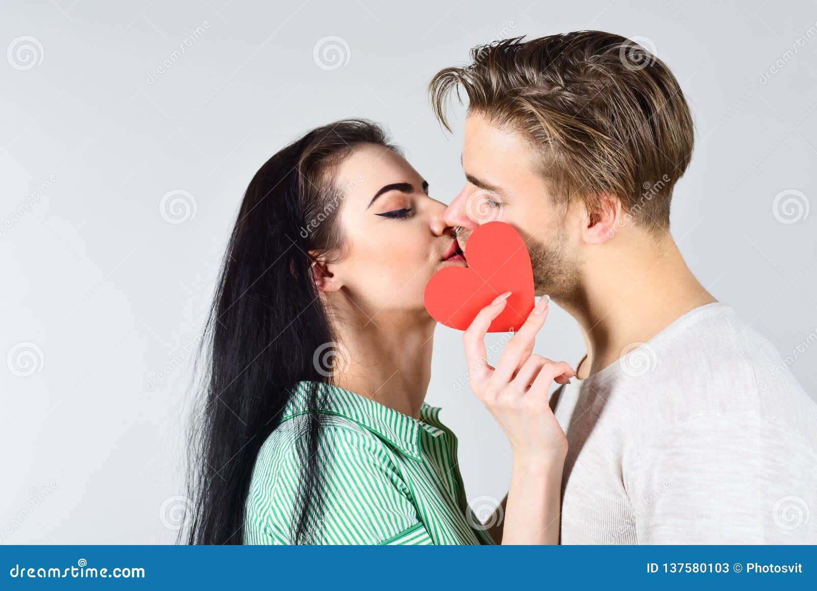 Couple in Love Kissing and Hide Lips Behind Heart Card. Celebrate ...