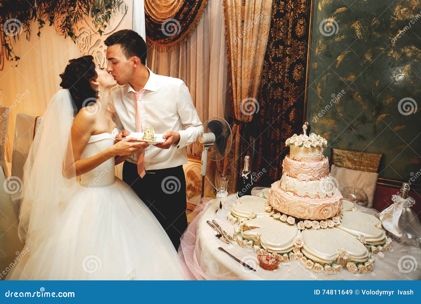 couple in love kissing near wedding cake