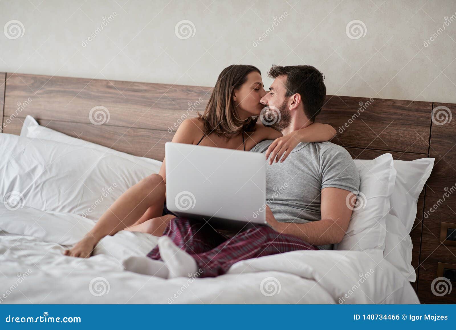 Couple in Love Kissing - Passionate Lovers Having Romantic and Intimate Moments on the Bed - Sex and Passion Concept Stock Photo