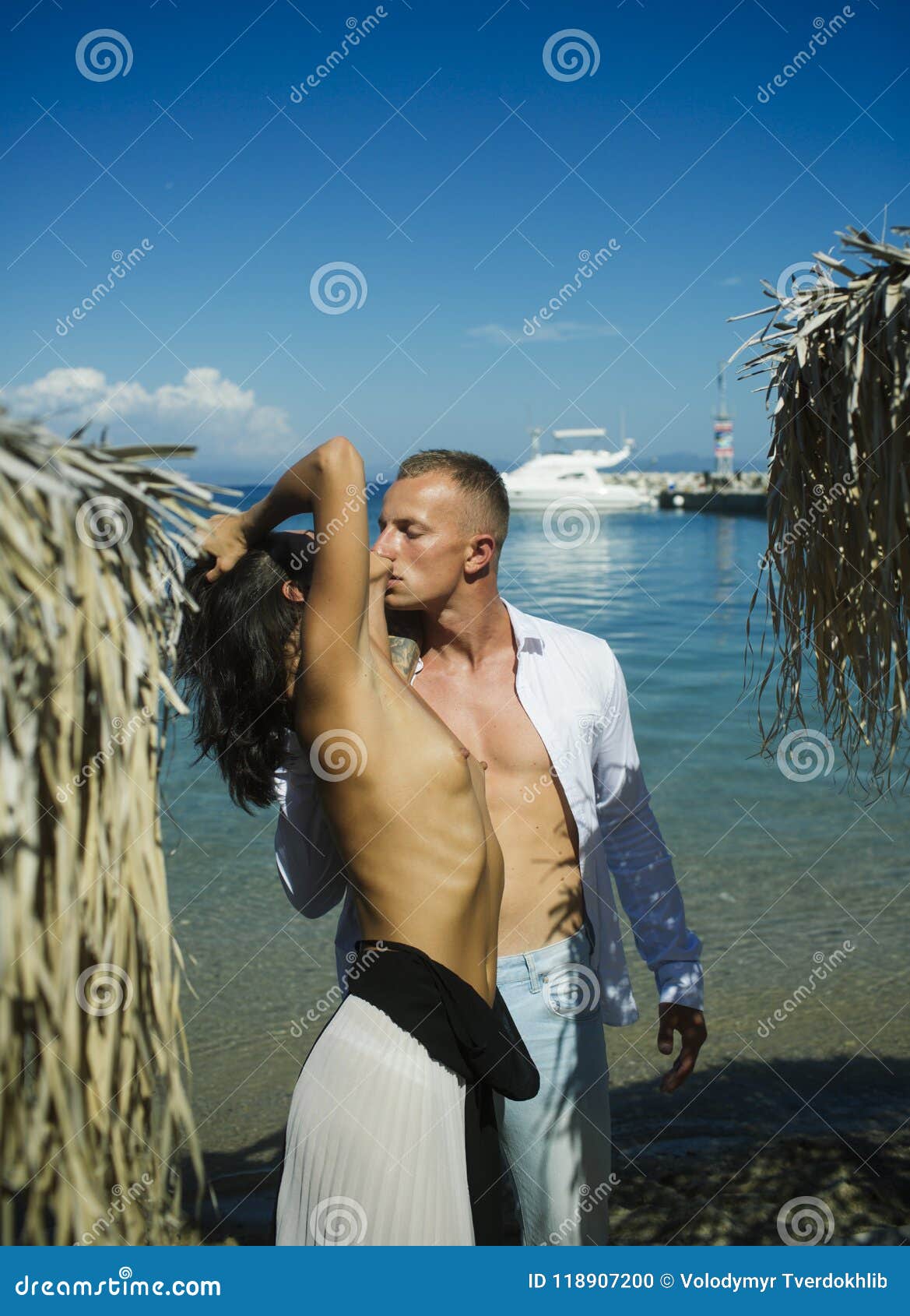 Cute couple is having a rest on the beach naked