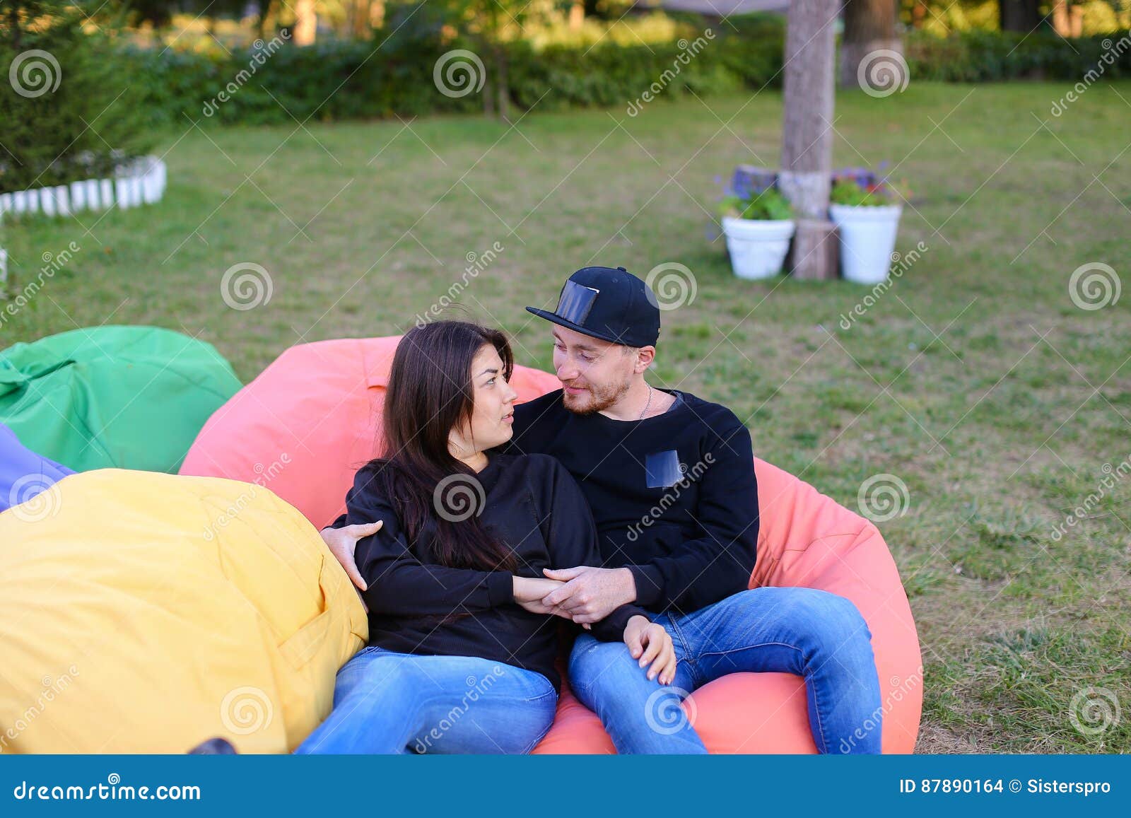 Couple In Love Sit And Talk In Armchairs Smiling Hugging And K St